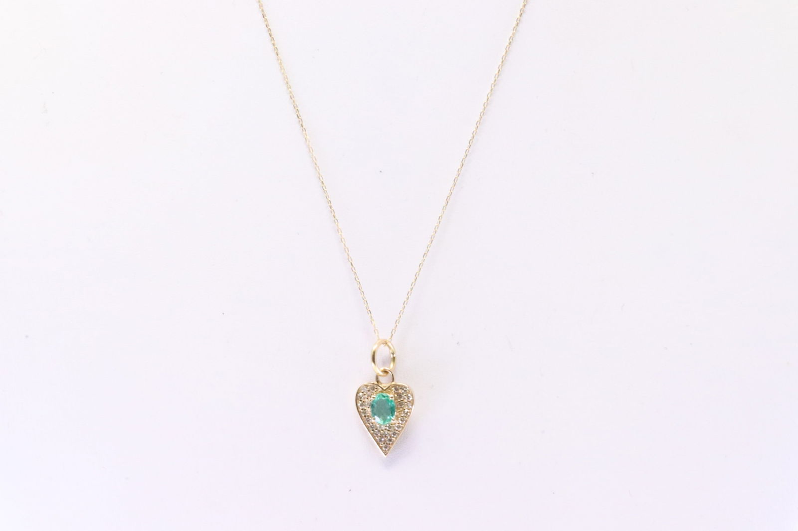 Emerald & Diamond Heart Pendant & Necklace 14Kt.: Ladies 14Kt Yellow Gold Emerald & Diamond Heart Pendant & Necklace. Necklace has Heart Design with Emerald / round Diamonds & A Necklace. Diamonds weight 0.30ctw. Necklace length: 16.00"
