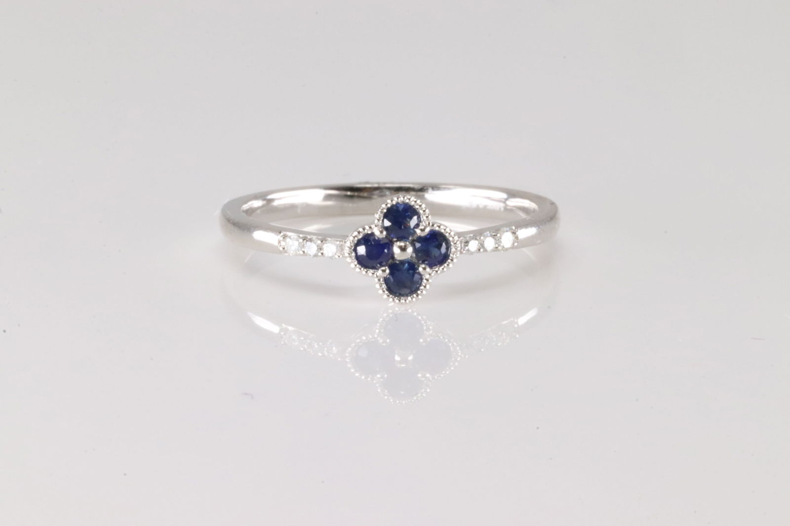 Sapphire & Diamond Ring 14Kt: 14Kt White Gold Sapphire & Diamond Ring. This ring has clover design with 4 blue sapphire and 6 round diamonds. Diamonds weight approx: 0.04ctw. Sapphires weight approx: 0.17ctw. Ring size: 6.25.