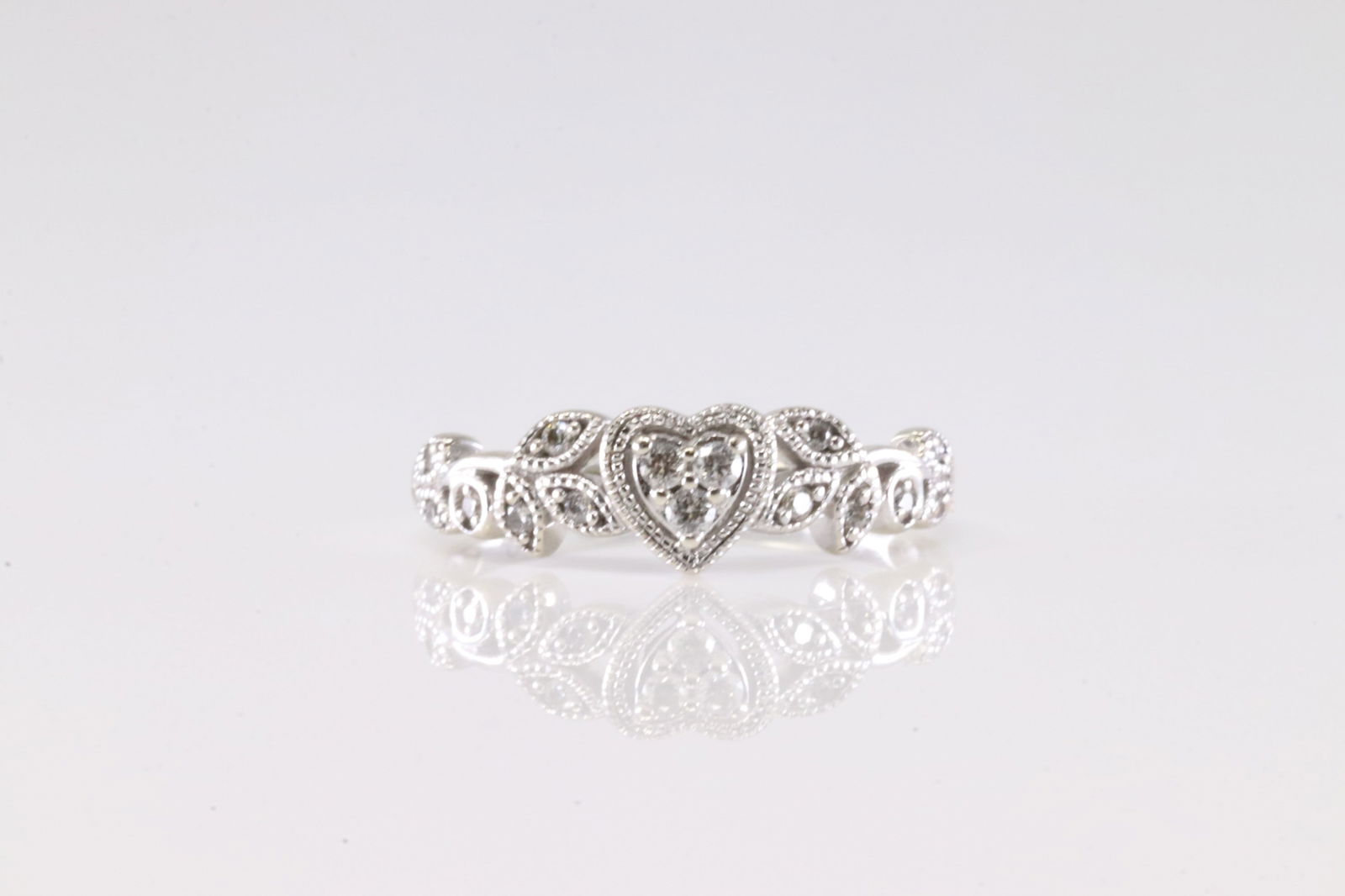 Diamond Heart Ring 10Kt.: Ladies 10Kt White Gold Diamond Heart Ring. This Charming Ring has Heart And Leaf Design with Sparkling Diamonds. 6.00. Total weight: 2.13 Grams.