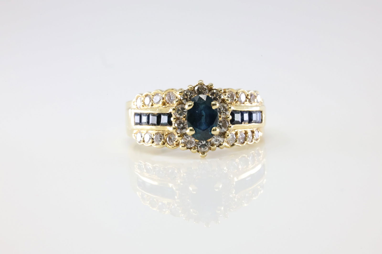 Sapphire & Diamond Gold Ring 14Kt.: Ladies 14Kt Yellow Gold Sapphire & Diamond Gold Ring. This Elegant Ring has A 9 Sapphiore Gemstones With 26 Round Sparkling Diamonds. Diamond Weight Approx: 0.55 ctw Ring Size: 8.50. Total Weight: