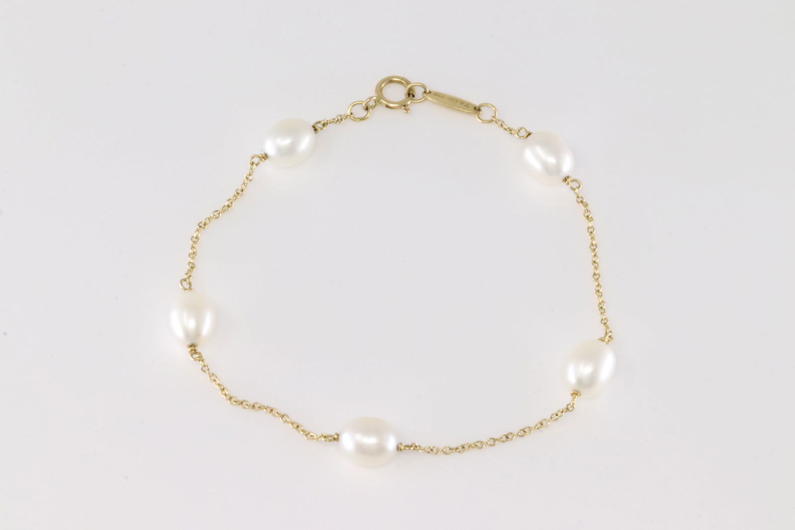 Tiffany & Co Pearl By The Yard Bracelet 18Kt.: Tiffany & Co 18Kt Yellow Gold Pearl By The Yard Bracelet. This Charming Bracelet has Five Freshwater Cultured Pearls. Bracelet length: 8.00. Total weight: 3.00 Grams.
