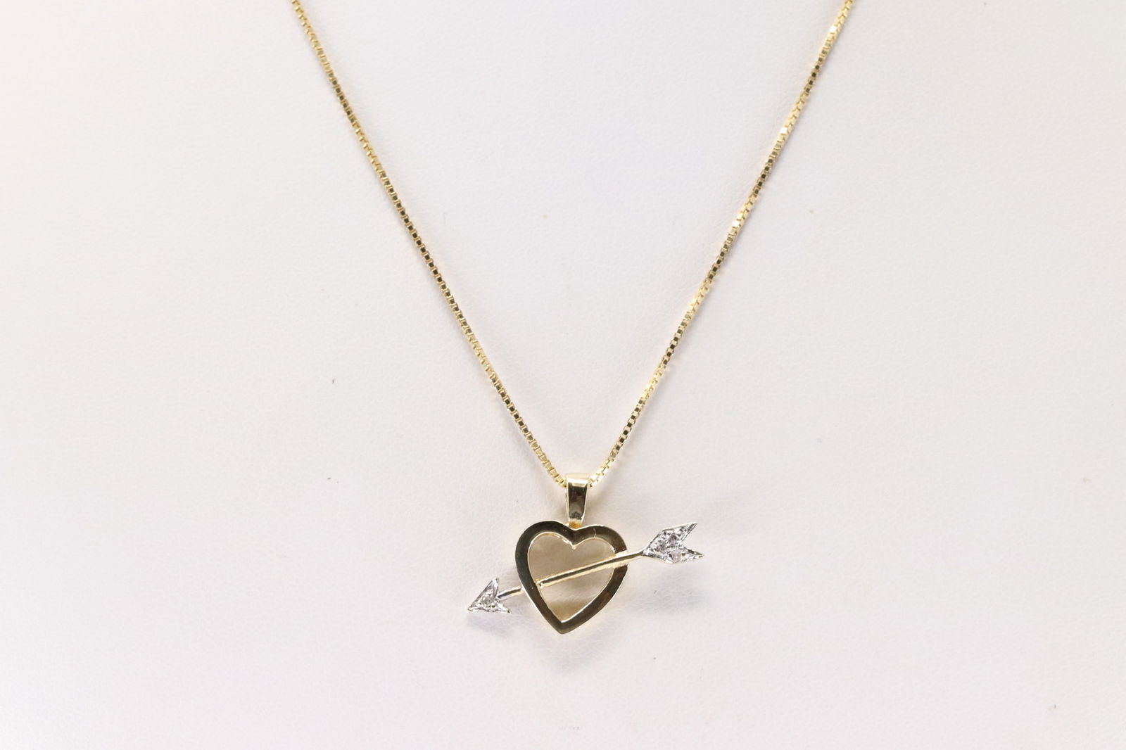 Diamond Heart & Arrow Pendant / Necklace 14Kt.: 14Kt Yellow Gold Diamond Heart & Arrow Pendant / Necklace. This Pendant has Heart / Arrow Design with 4 Sparkling Diamonds and A 14K Necklace. Necklace length:18.00" Total weight: 3.80 Grams.