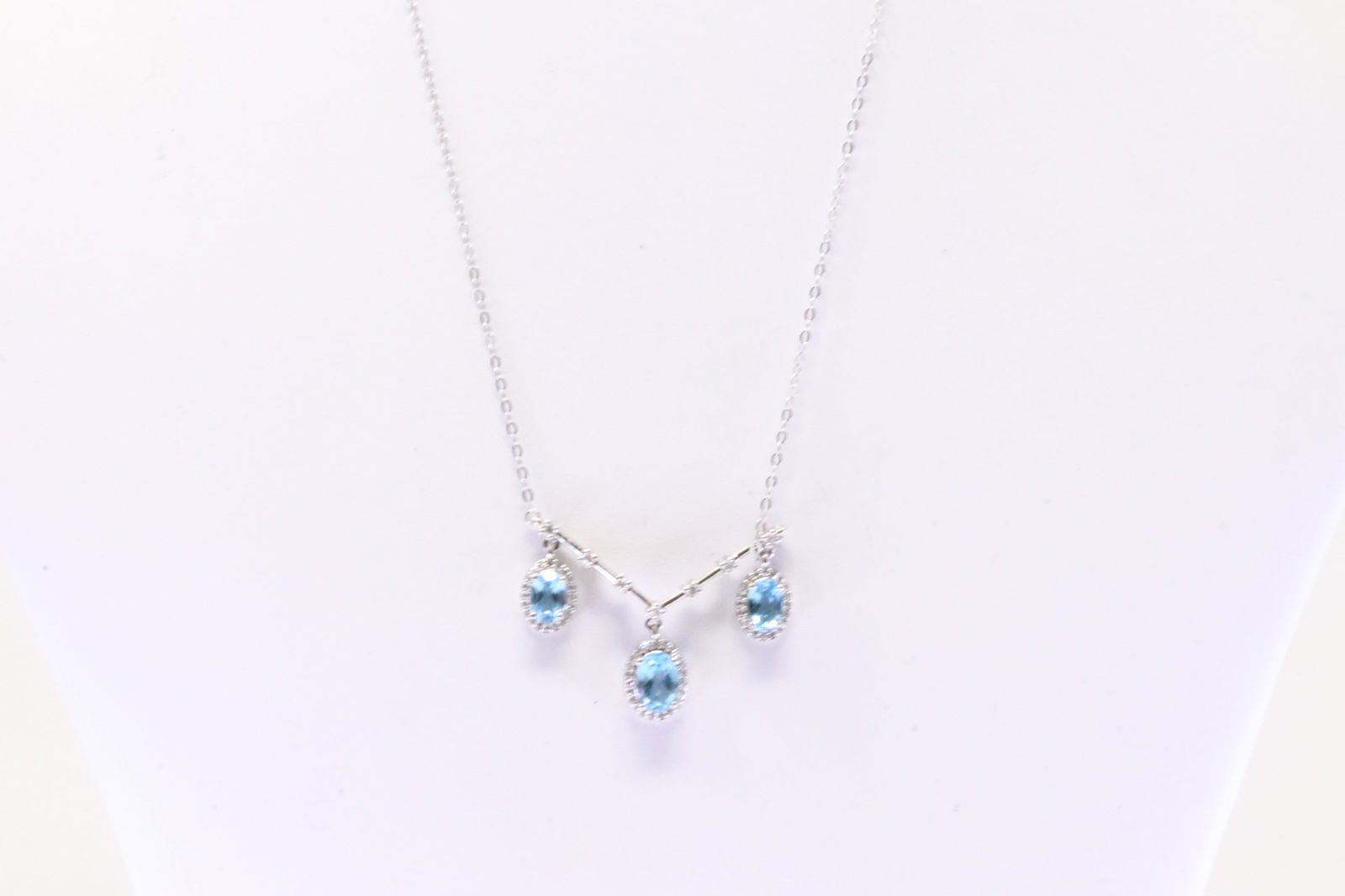 Blue Topaz & Diamond Necklace 10Kt.: Ladies 10Kt White Gold Blue Topaz & Diamond Necklace. Necklace has 3 Oval Blue Topaz Gems with round Diamonds. Diamonds weight: 0.25ctw. Necklace length: 16.00" Total weight: 3.20 Grams.
