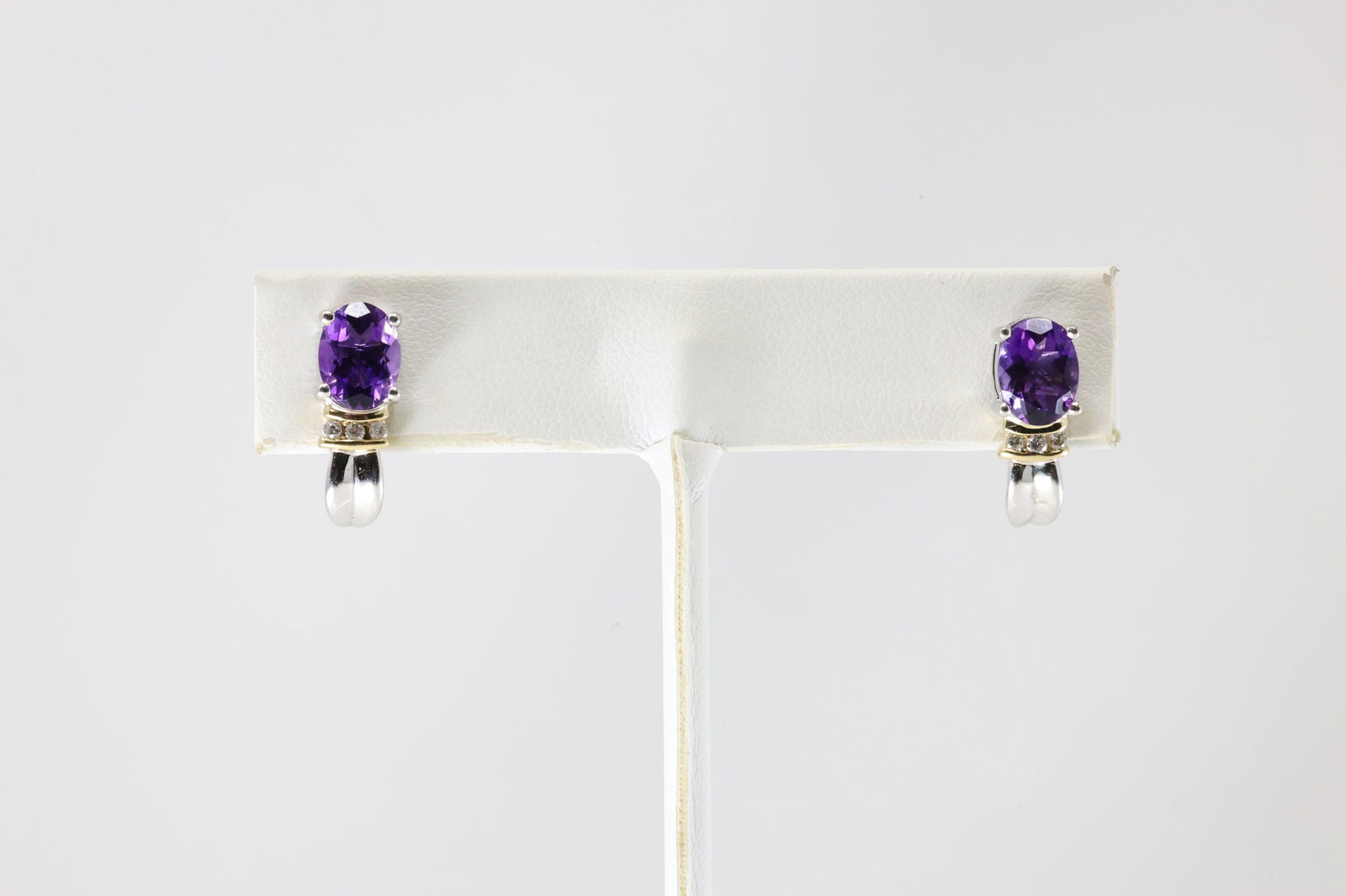 Amethyst & Diamond Earring 10Kt.: Ladies 10Kt White Gold Amethyst & Diamond Earring. This Earring's has 2 Charming Amethyst Gemstones With 6 Round Sparkling Diamonds. Total Weight: 3.29 Grams.