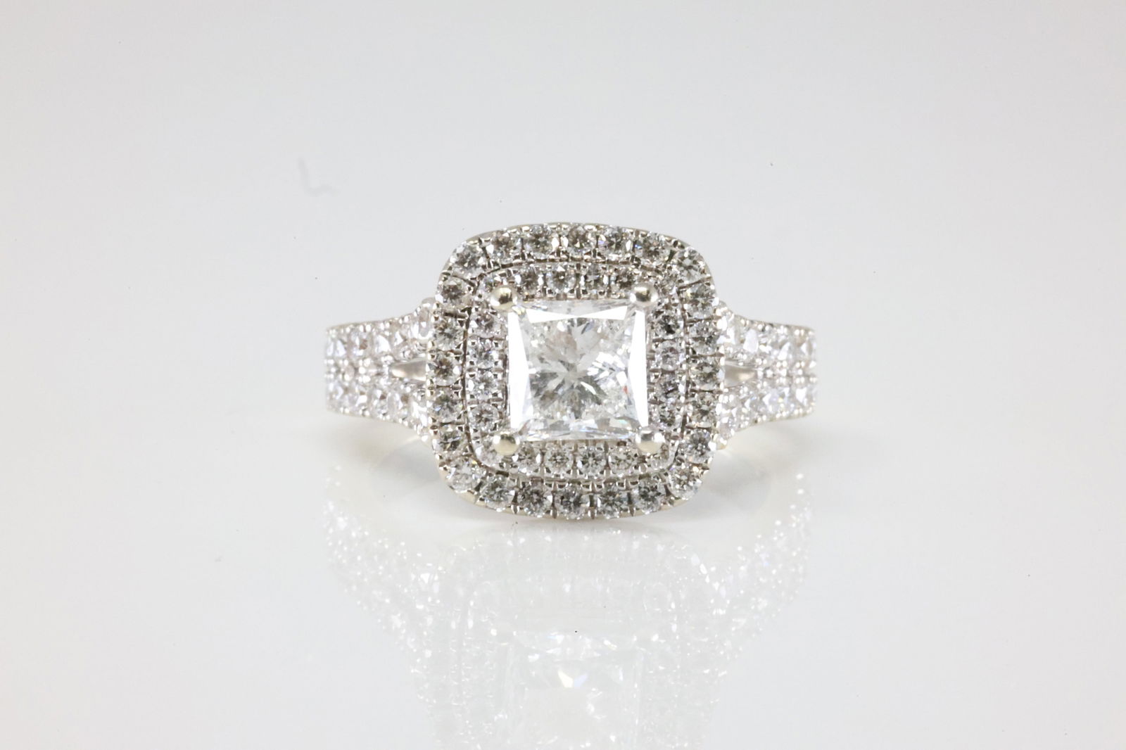 Ladies Engagment Diamond Ring 14Kt.: Ladies 14Kt White Gold Sapphire & Diamond Ring. This Charming Ring has 2 Sapphire Gemstones With 99 Round Sparkling Diamonds with a Princess Cut diamond set in the center. Diamond Weight Approx: