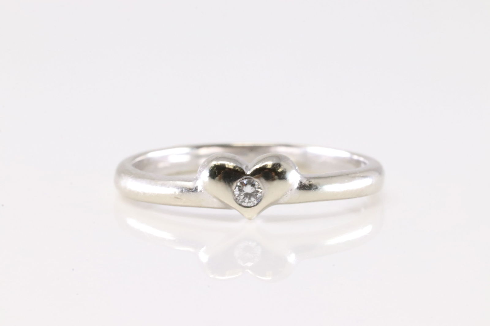 Diamond Ring 18Kt.: Ladies 18Kt White Gold Diamond Ring. This Charming Ring has Heart Design With A Sparkling Diamond. Ring Size: 5.50. Total Weight: 2.00 Grams.