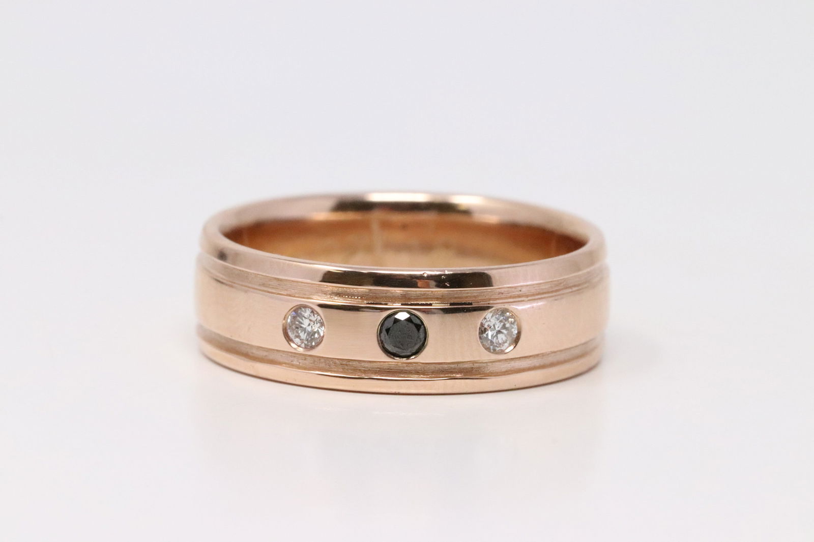 14Kt Rose Gold Diamond Ring.: 14Kt Rose Gold Diamond Ring. Ring has 2 Diamonds White & One Black Diamond. Ring size: 9.50. Total weight: 8.55 Grams.