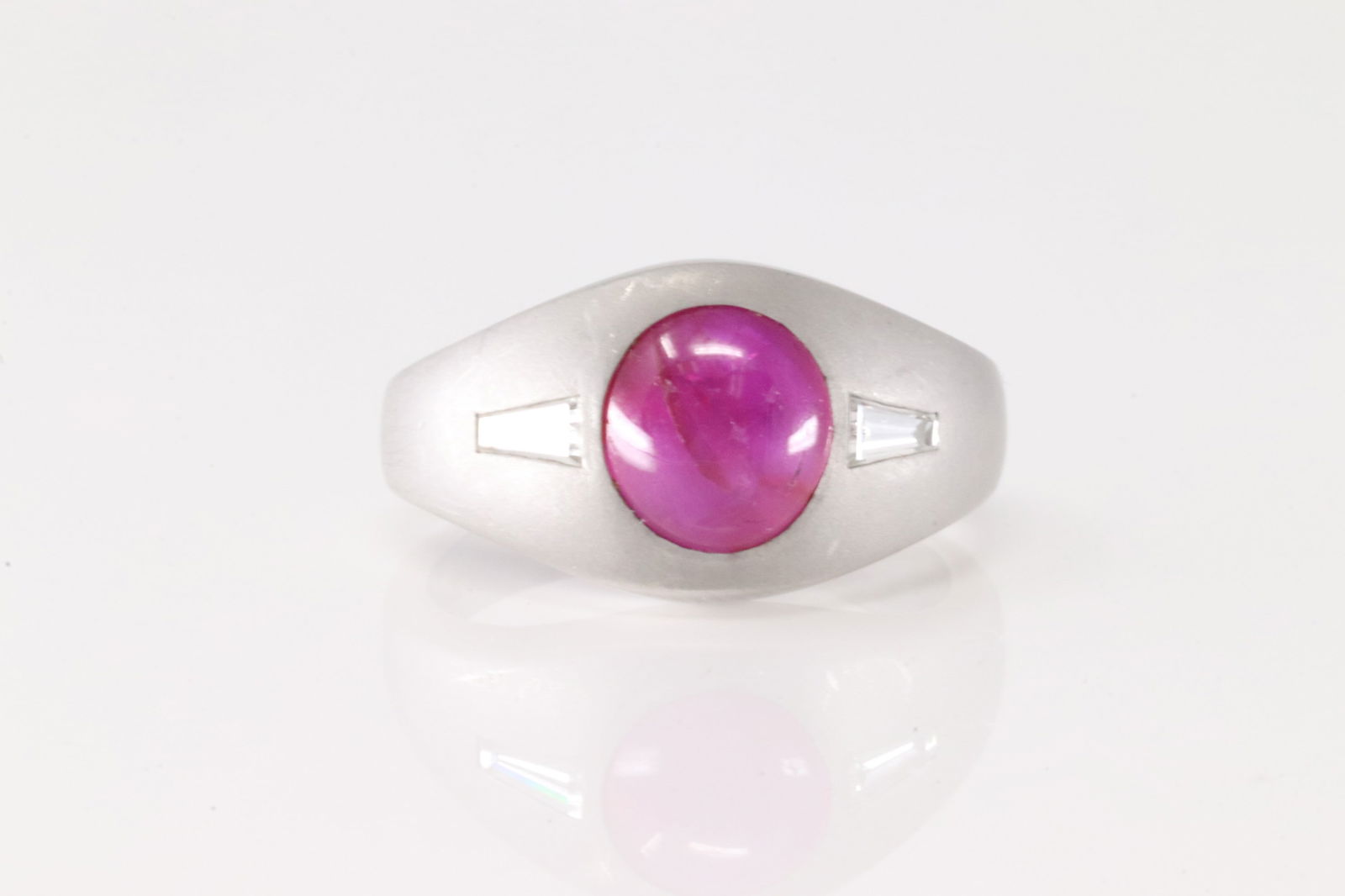 Pink Sapphire Ring 14Kt.: 14Kt White Gold Pink Sapphire & Baguette Diamond Ring. This white ring has one single beautiful pink sapphire round set on the center with 2 baguette diamonds to the sides. Sapphire weight approx: