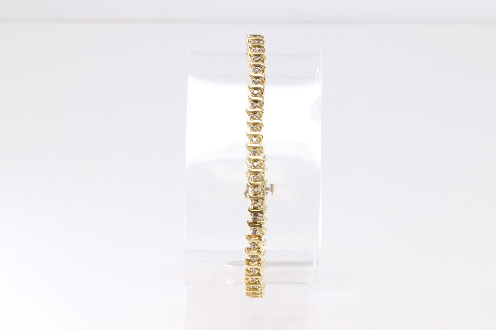 14KT Diamond Gold Bracelet: This exquisite gold bracelet features a series of intricately linked segments, each adorned with sparkling diamonds. Its elegant design makes it the perfect accessory for any sophisticated ensemble.