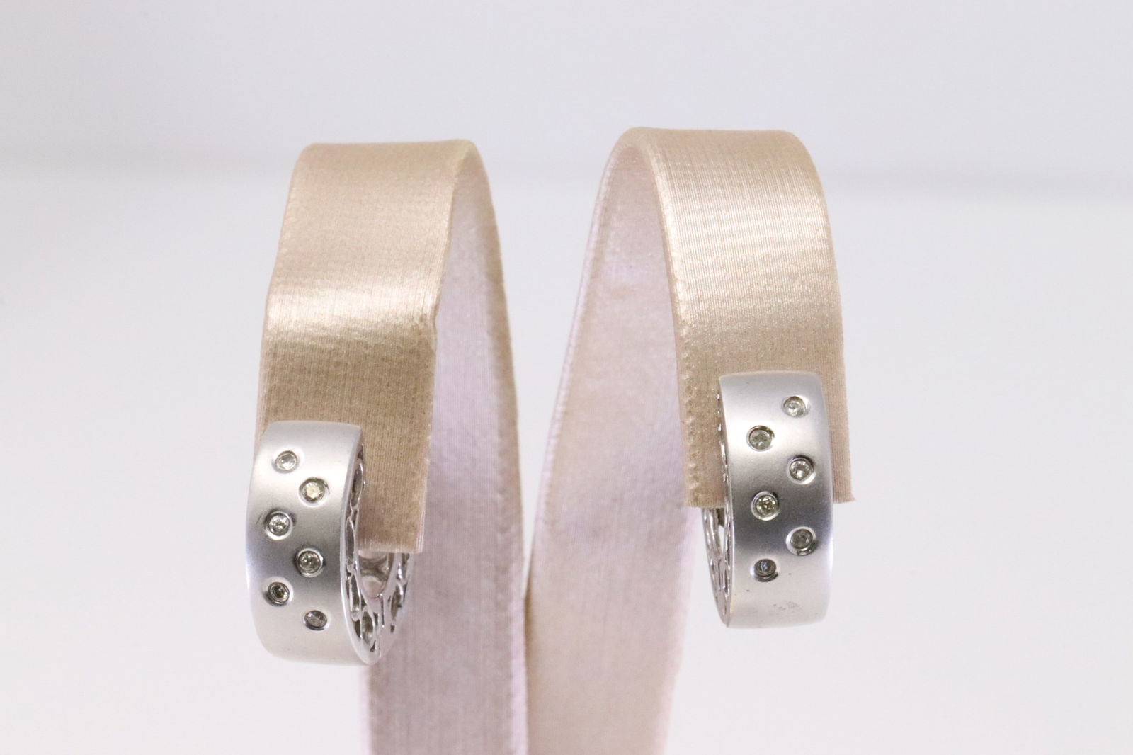 14Kt White Gold Huggies Diamond Earring.: Ladies 14Kt White Gold Huggies Diamond Earring. Earring has 6 round Diamonds to each. Total weight: 7.47 Grams. AY-3E8FJ