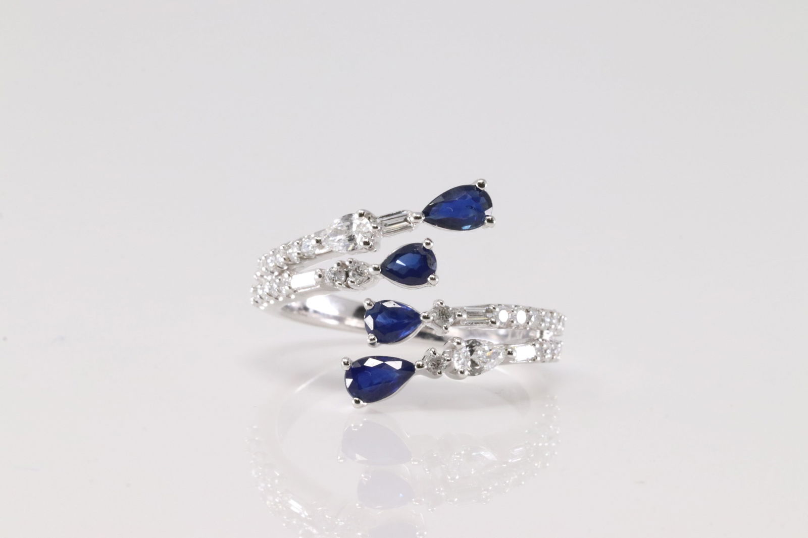 Sapphire & Diamond Ring 14kt.: Ladies 14kt White Gold Sapphire & Diamond Ring. This Ring 4 Oval Sapphire With 33 Round Sparkling Diamonds. Sapphire Weight: 0.78ctw. Diamond Weight: 0.59ctw. Ring Size: 6.50.