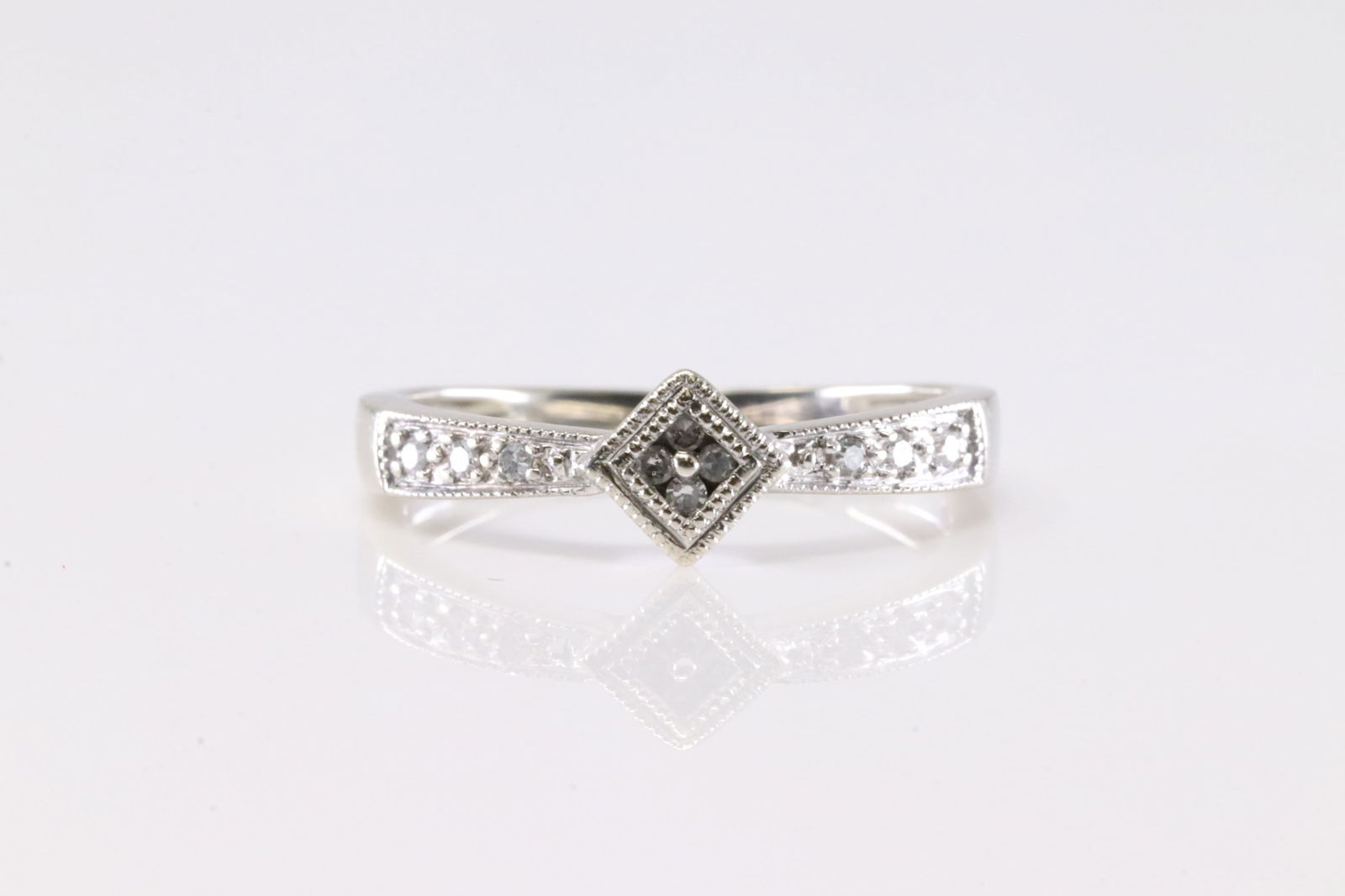 Diamond Ring 10Kt.: Ladies 10Kt White Gold Diamond Ring. This Ring has 10 Round Sparkling Diamonds. Ring Size: 6.50.