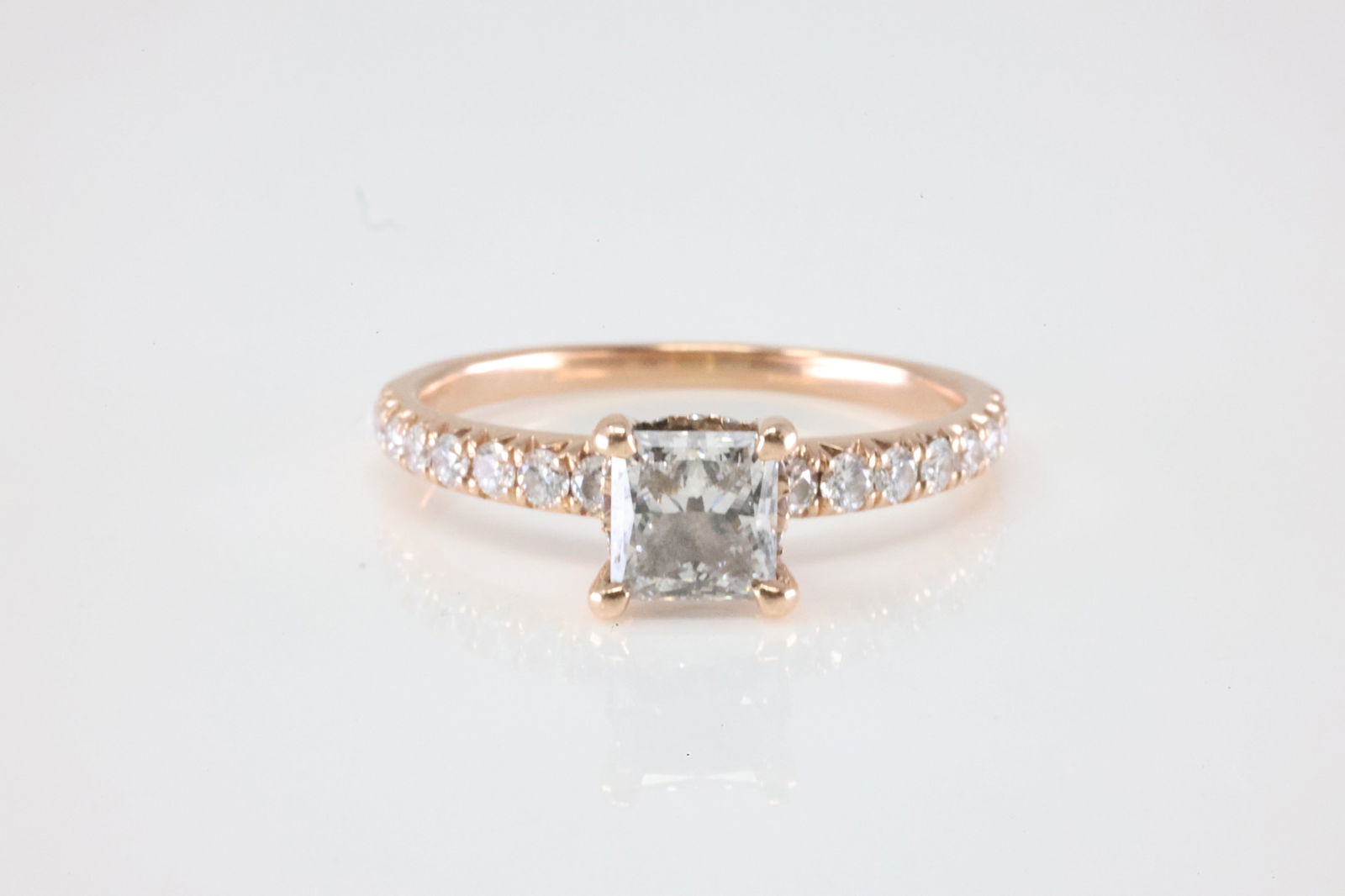 Rose Gold Diamond Ring 14Kt.: Ladies 14Kt Rose Gold Diamond Ring. This Gorgeous Ring has 29 Round Sparkling Diamonds with a princess cut diamond set in the center. Diamond Weight Approx: 1.50ctw. Ring Size: 6.50. Total Weight:
