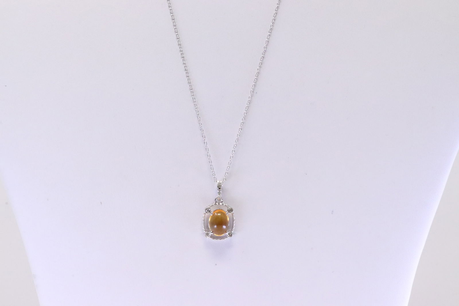 Citrine & Diamond Pendant / Necklace 10Kt.: Ladies 10Kt White Gold Citrine & Diamond Pendant / Necklace. Necklace has Oval Citrine Gemstone with round Diamonds. Diamonds weight: 0.05ctw. Necklace length: 18.00"