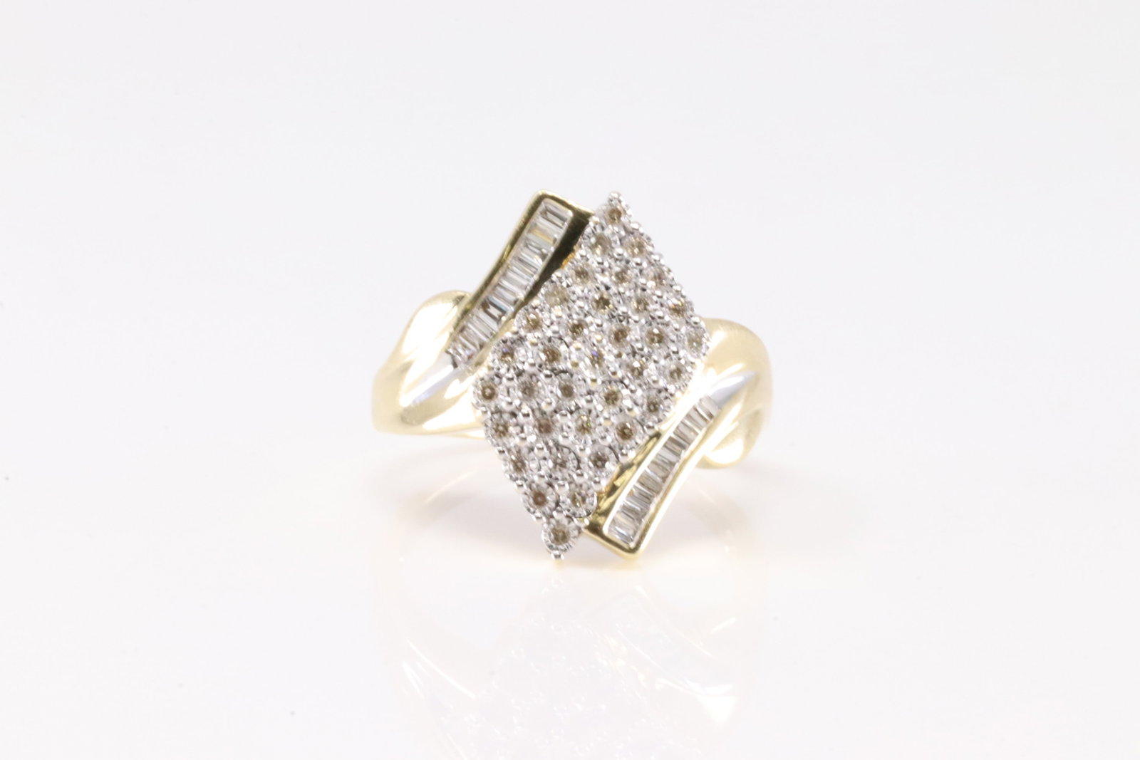 Diamond Ring 10Kt.: Ladies 10Kt Yellow Gold Diamond Ring. This Elegant Ring has 20 Baguette / 35 Round Sparkling Diamonds. Diamond Weight Approx: 0.70 ctw Ring Size: 9.50. Total Weight: 5.61 Grams.