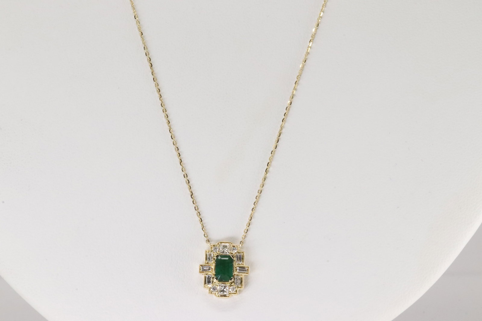 Emerald & Diamond Pendant / Necklace 14Kt.: Ladies 14Kt Yellow Gold Emerald & Diamond Pendant / Necklace. This Necklace has an Charming Pendant with Green Merald on the Center Surrender by Round & Baguette Diamonds. Diamonds weight: 0.34ctw. Em