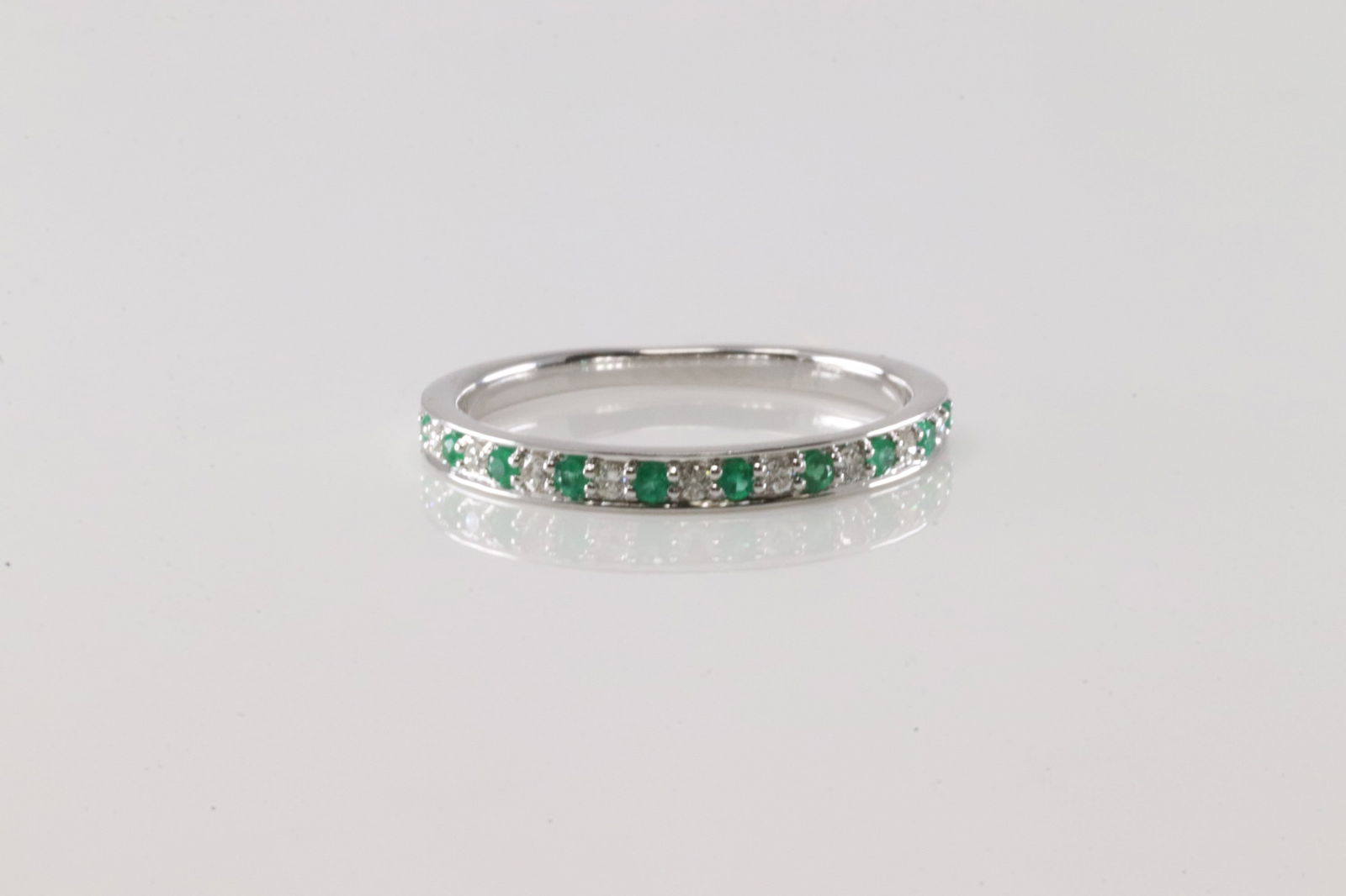 Emerald & Diamond Ring 14Kt.: Ladies 14Kt White Gold Emerald & Diamond Ring. This Ring has 10 Green emeralds with 9 round Diamonds. Diamonds weight: 0.09ctw. Emeralds weight: 0.10ctw. Ring size: 6.25.
