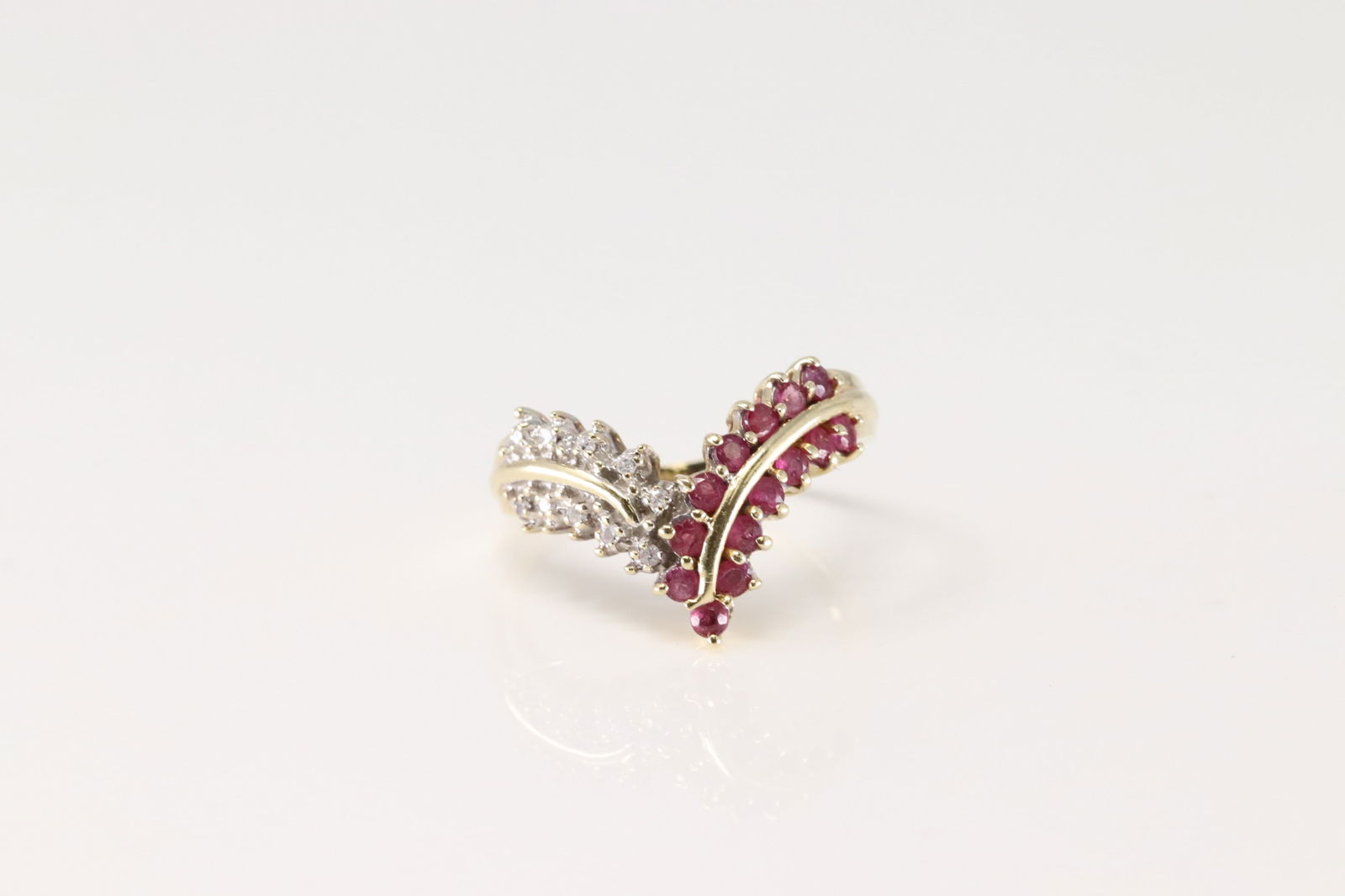 Ruby & Diamond Ring 14Kt.: Ladies 14Kt Yellow Gold Ruby & Diamond Ring. This Elegant Ring has V Design with 14 Pink Rubies and 10 Sparkling Diamonds. Ring size: 8.50. Total weight: 3.60 Grams.
