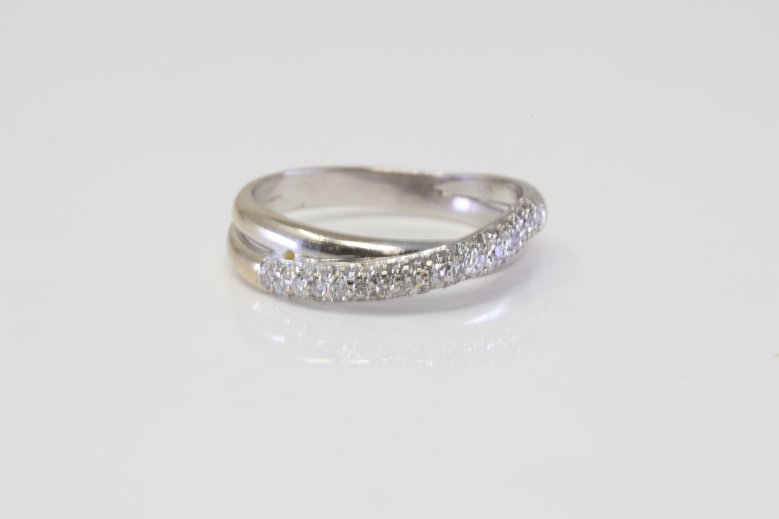 Diamond Ring 18Kt.: 18Kt White Gold Diamond Ring. Ring has Double twist Band with round Diamonds. Diamonds weight approx: 1.00cttw. There are more than 50 round diamonds. Ring size: 10.75. Total weight: 6.20 Grams.