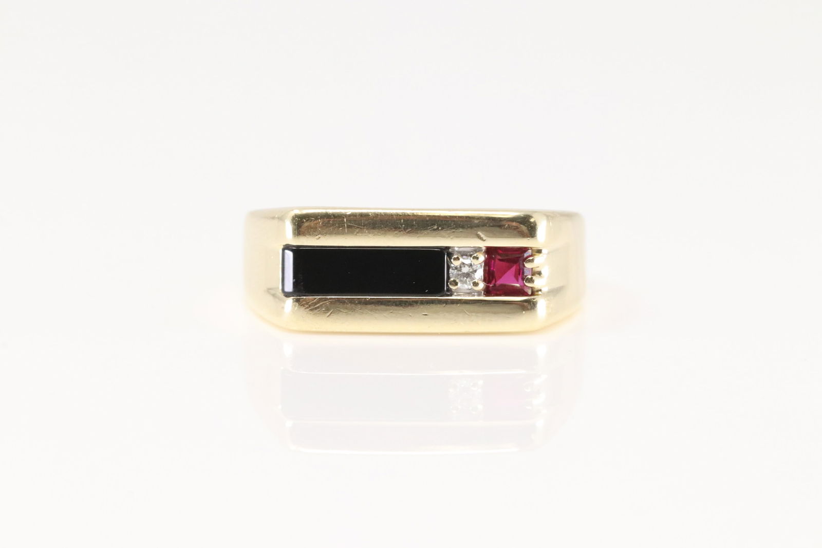 Multi-Color Gemstone & Diamond Ring 10Kt.: 14Kt Yellow Gold Multi-Color Gemstone & Diamond Ring. This Elegant Ring has Black Onyx / Ruby and 1 Sparkling Diamond. Ring size: 9.00. Total weight: 6.20 Grams.