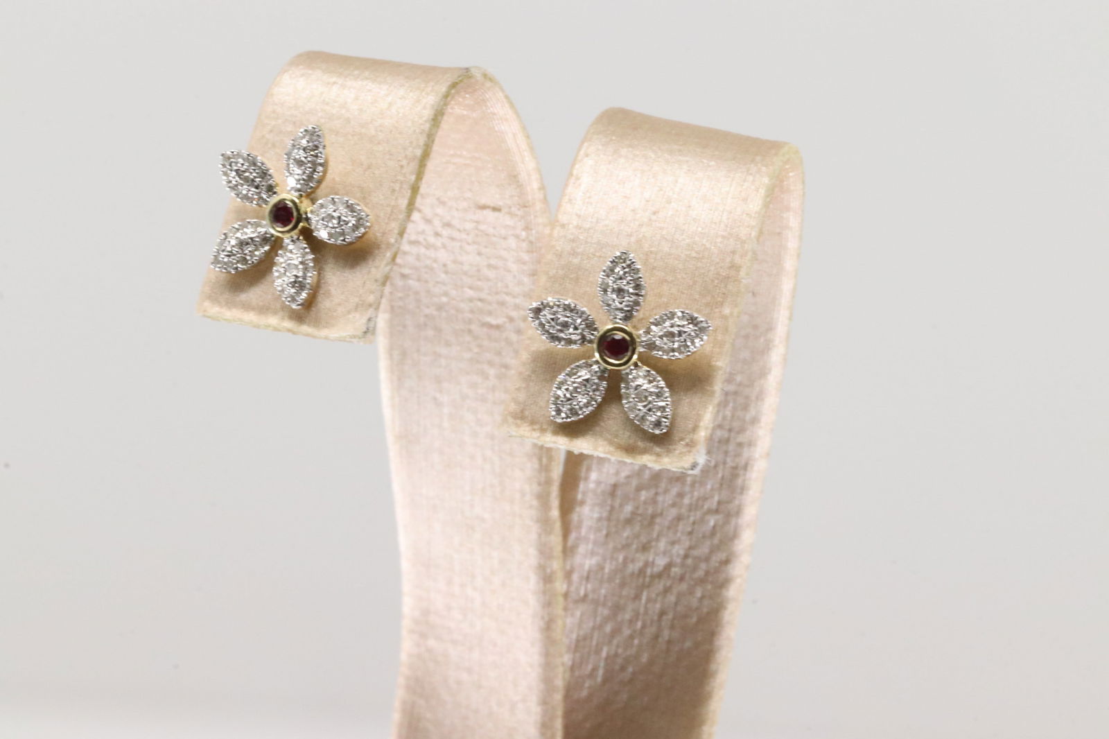 Ruby & Diamond Stud Earring 10Kt.: Ladies 10Kt Yellow Gold Ruby & Diamond Stud Earring. This Earring's Has Beautiful Flower Desing With Sparkling Diamonds & Gorgeous Ruby Gem In The Center. Diamond Weight: 0.25ctw.