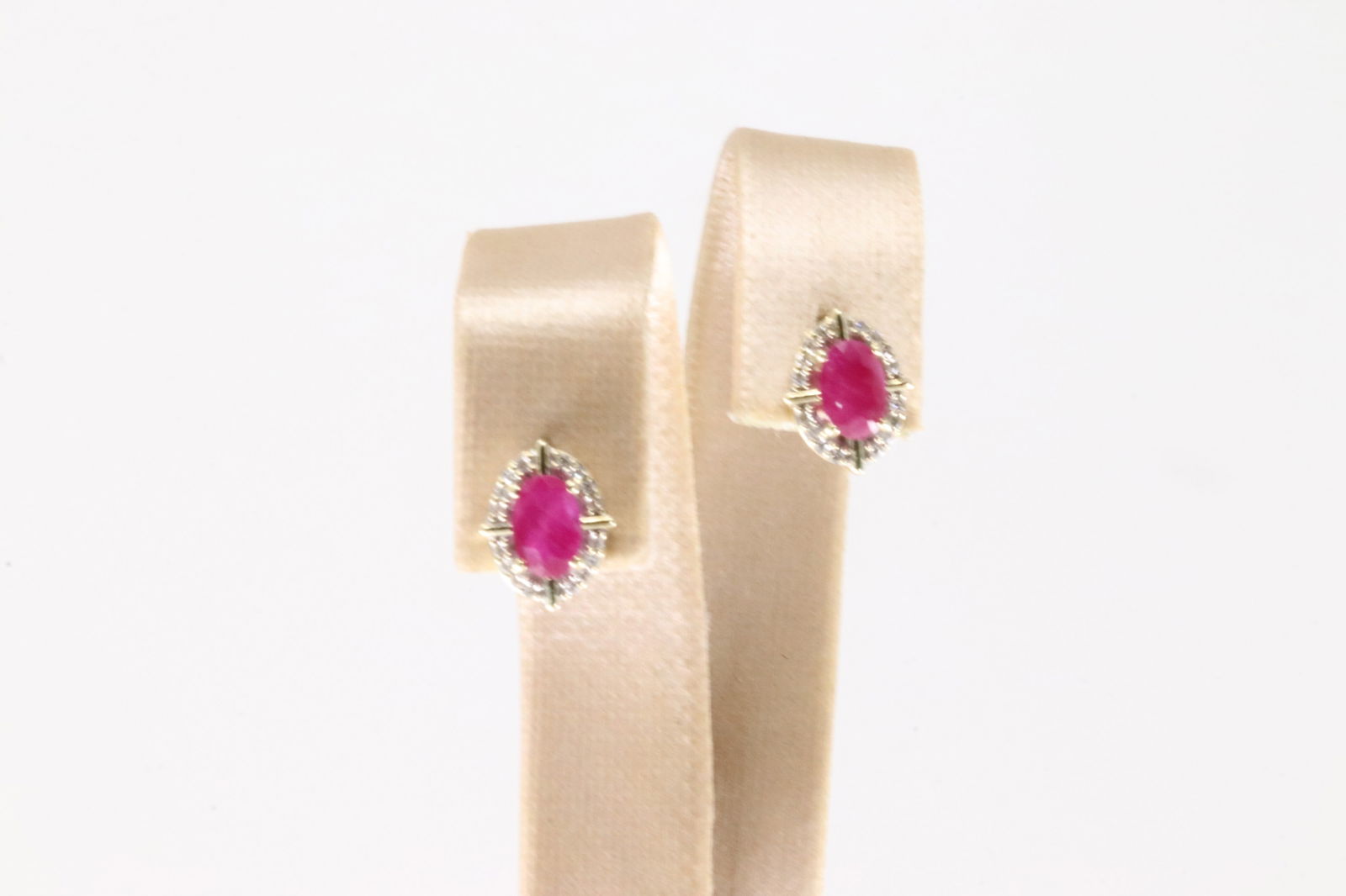 Ruby & Diamond Stud Earring 10Kt.: Ladies 10Kt Yellow Gold Ruby & Diamond Stud Earring. This Charming Stud Earring has Oval Rubies Surrender By Sparkling Diamonds. Diamonds weight: 0.15ctw.