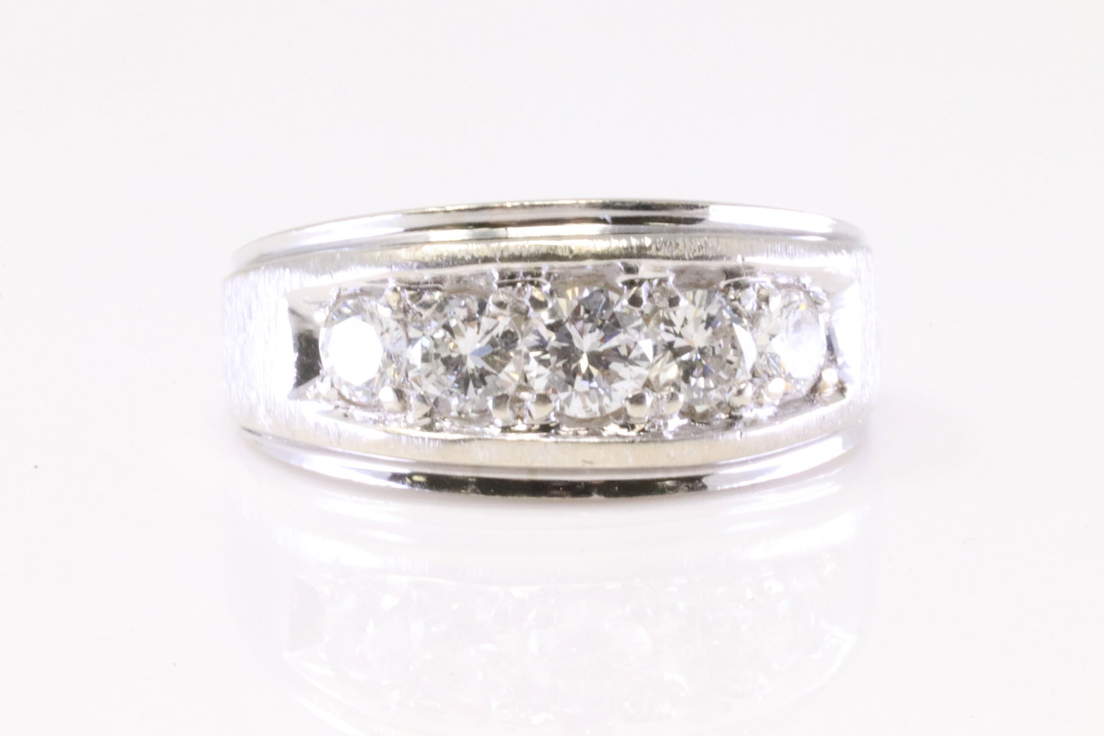 14KT White Gold Diamond Ring: A 14kt White Gold Diamond ring. Ring has 5 round brilliant diamonds. Diamonds weigh approx 1.00ctw. Diamonds are VS-SI, F color. Ring size: 8.00. Total weight: 7.30 grams.