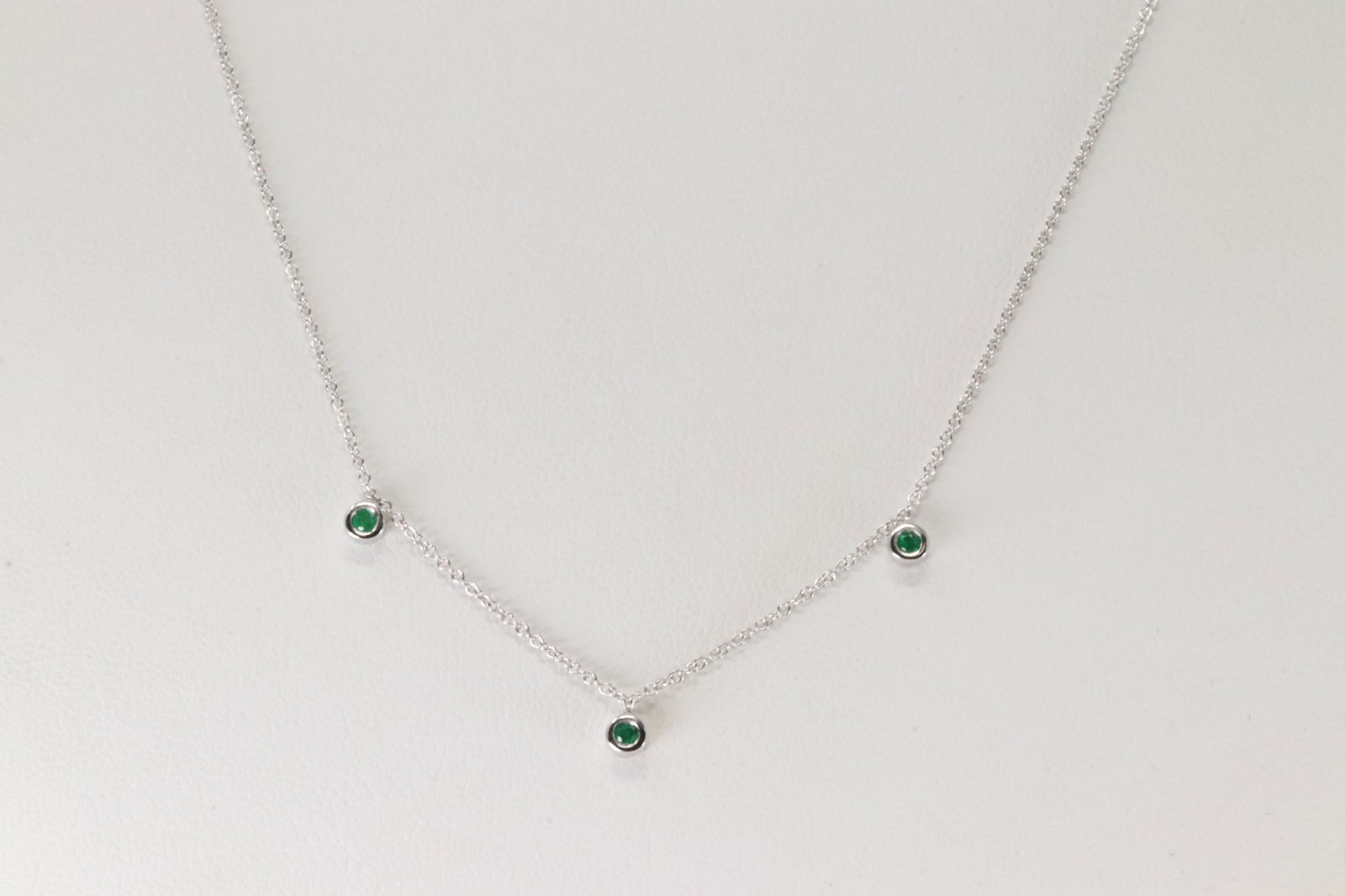 Emerald Necklace 14Kt.: Ladies 14Kt White Gold Emerald Necklace. This Necklace has 3 Round Emeralds. Emeralds weight: 0.07ctw. Necklace length: 18.00"