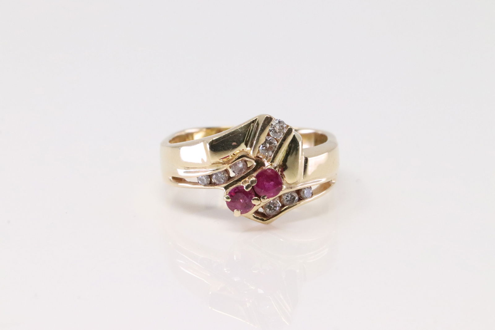 Ruby & Diamond Ring 14Kt.: Ladies 14Kt Yellow Gold Ruby & Diamond Ring. Ring has 2 Ruby with 8 Diamonds. Diamonds weight approx: 0.25ctw.Ring size: 6.75. total weight: 6.70 Grams.