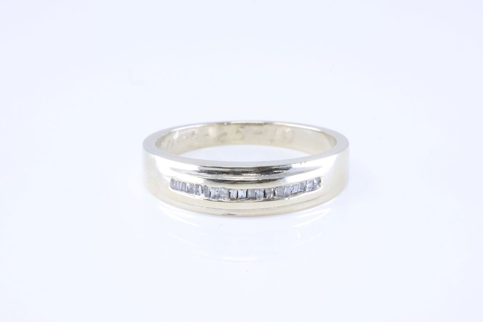 Diamond Ring 14Kt.: 14Kt White Gold Diamond Ring. This Charming band Ring has Baguette Sparkling Diamonds. Ring size: 9.25. Total weight: 5.20 Grams.