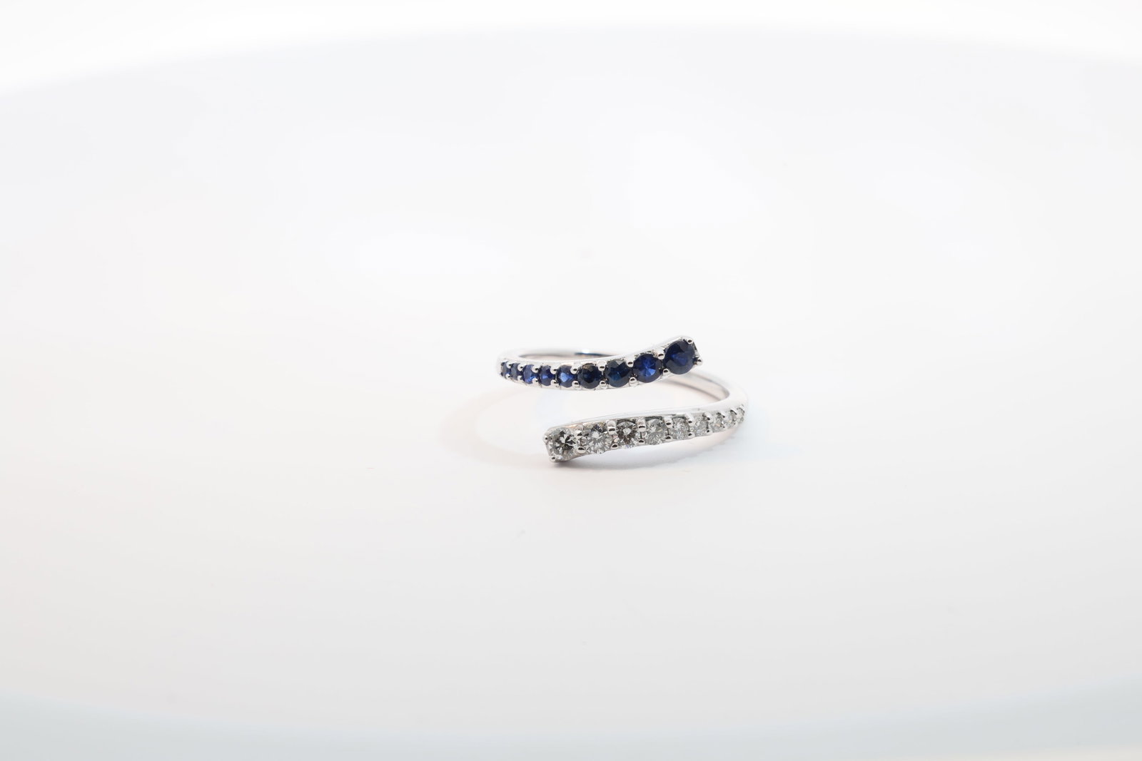 Sapphire & Diamond Bypass Ring 14Kt.: Ladies 14Kt White Gold Sapphire & Diamond Bypass Ring. Ring has Design with 9 Sapphire's Gems & 9 round Diamonds. Diamonds weight: 0.29ct. Sapphire's weight: 0.34ct. Ring size: 7.00. Total weight: