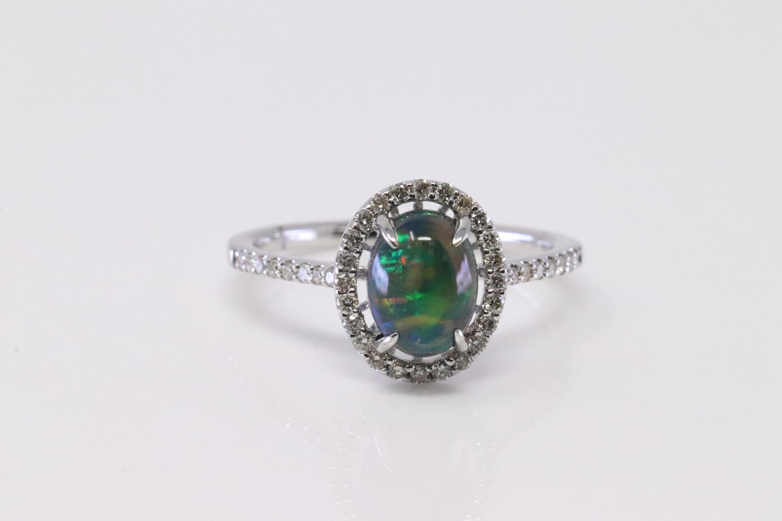 Ethiopian Opal & Diamond Ring 14Kt.: Ladies 14Kt White Gold ethiopian opal & Diamond Ring. Ring has one ethiopian opal weighing 0.97ct with 40 round Diamonds. Diamonds weight: 0.24 ctw. Ring size: 6.50. Total weight: 2.60 Grams.