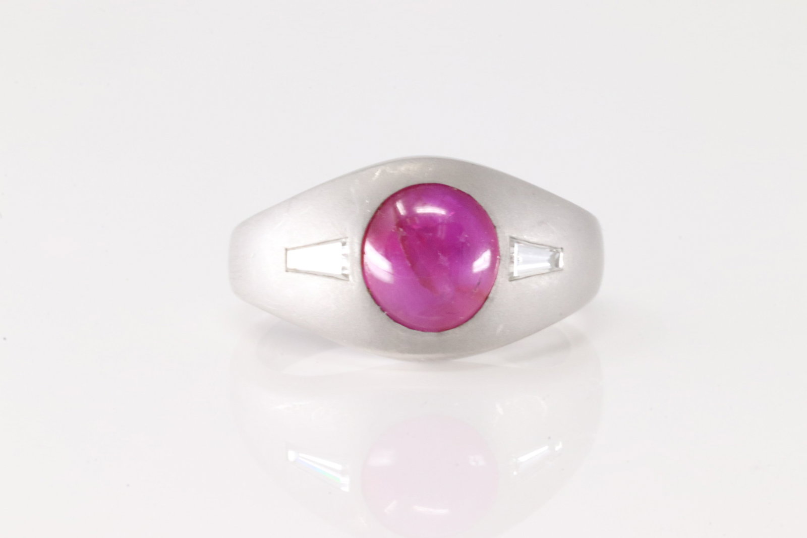 Pink Sapphire Ring 14Kt.: 14Kt White Gold Pink Sapphire & Baguette Diamond Ring. This white ring has one single beautiful pink sapphire round set on the center with 2 baguette diamonds to the sides. Sapphire weight approx: