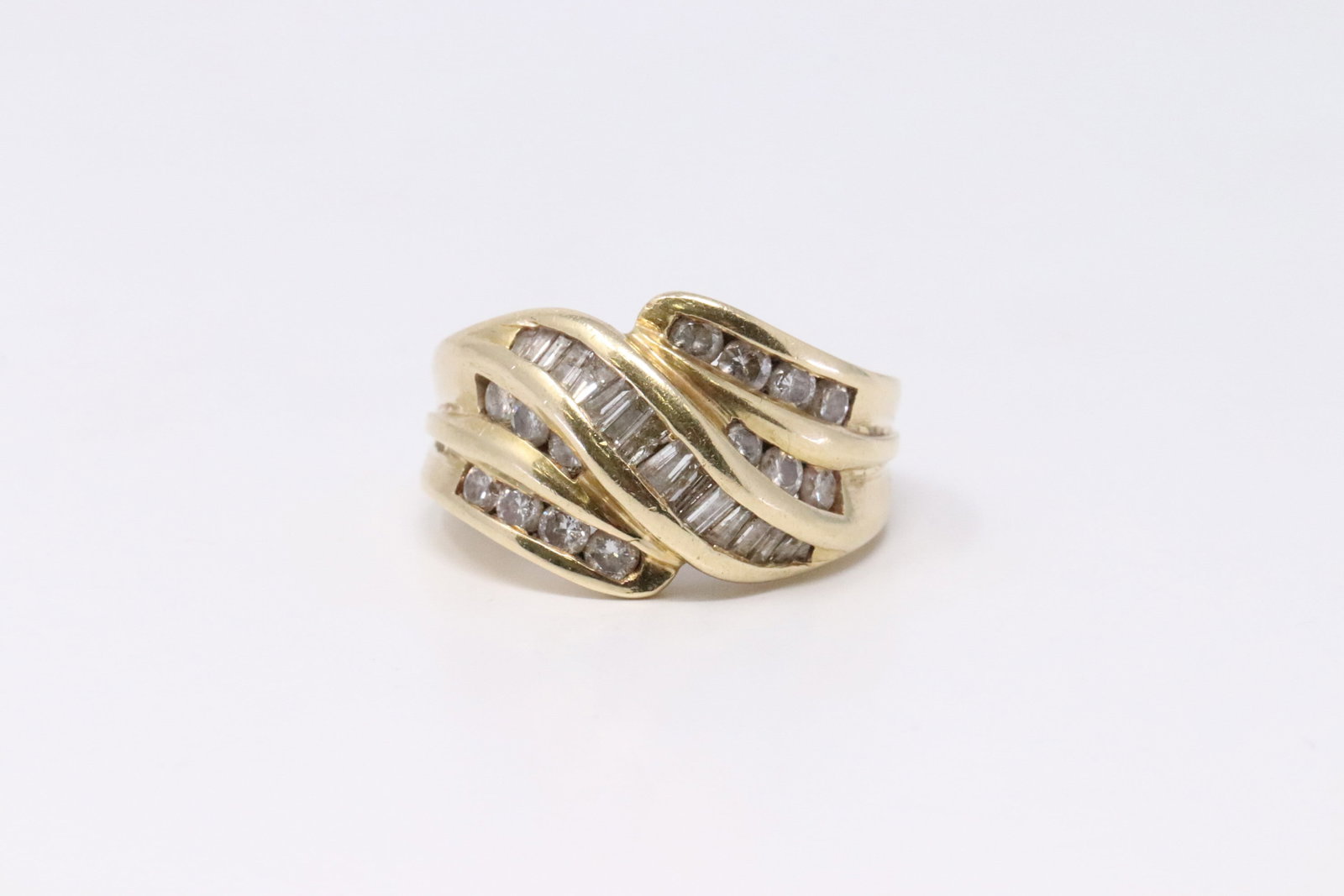 14KT Lady's Yellow Gold Diamond Ring.: 14KT Lady's Yellow Gold Diamond Ring. Ring has Baguette cut diamonds & 14 Round Diamonds. Diamonds weight approx 1.00ctw. Ring Size: 6.00. Total Weight: 7.07 Grams.