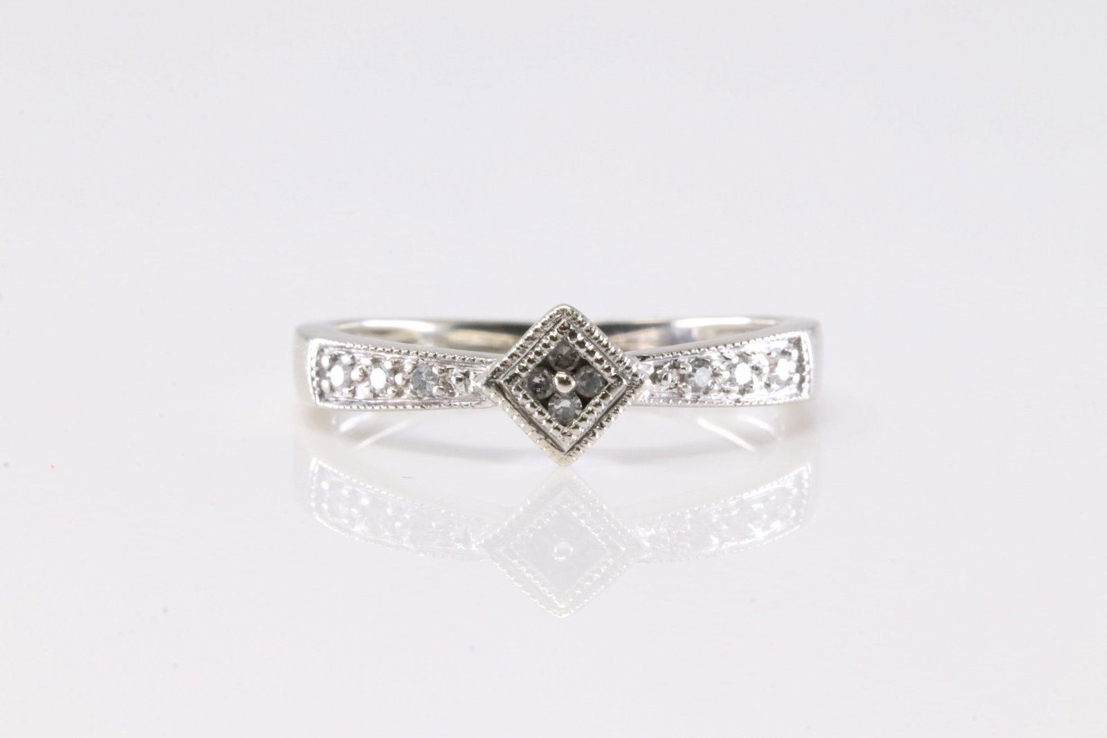 Diamond Ring 10Kt.: Ladies 10Kt White Gold Diamond Ring. This Ring has 10 Round Sparkling Diamonds. Ring Size: 6.50.