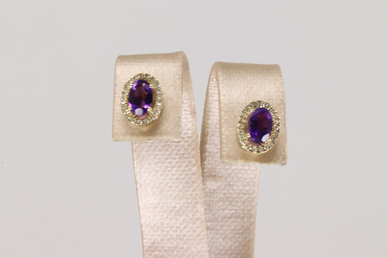 Amethyts & Diamond Stud Earring By 10Kt.: Ladies 10Kt Yellow Gold Amethyts & Diamond Stud Earring. This Charming Stud Earring's has Purple Amethyts with Sparkling Diamonds. Diamonds weight: 0.15ctw.