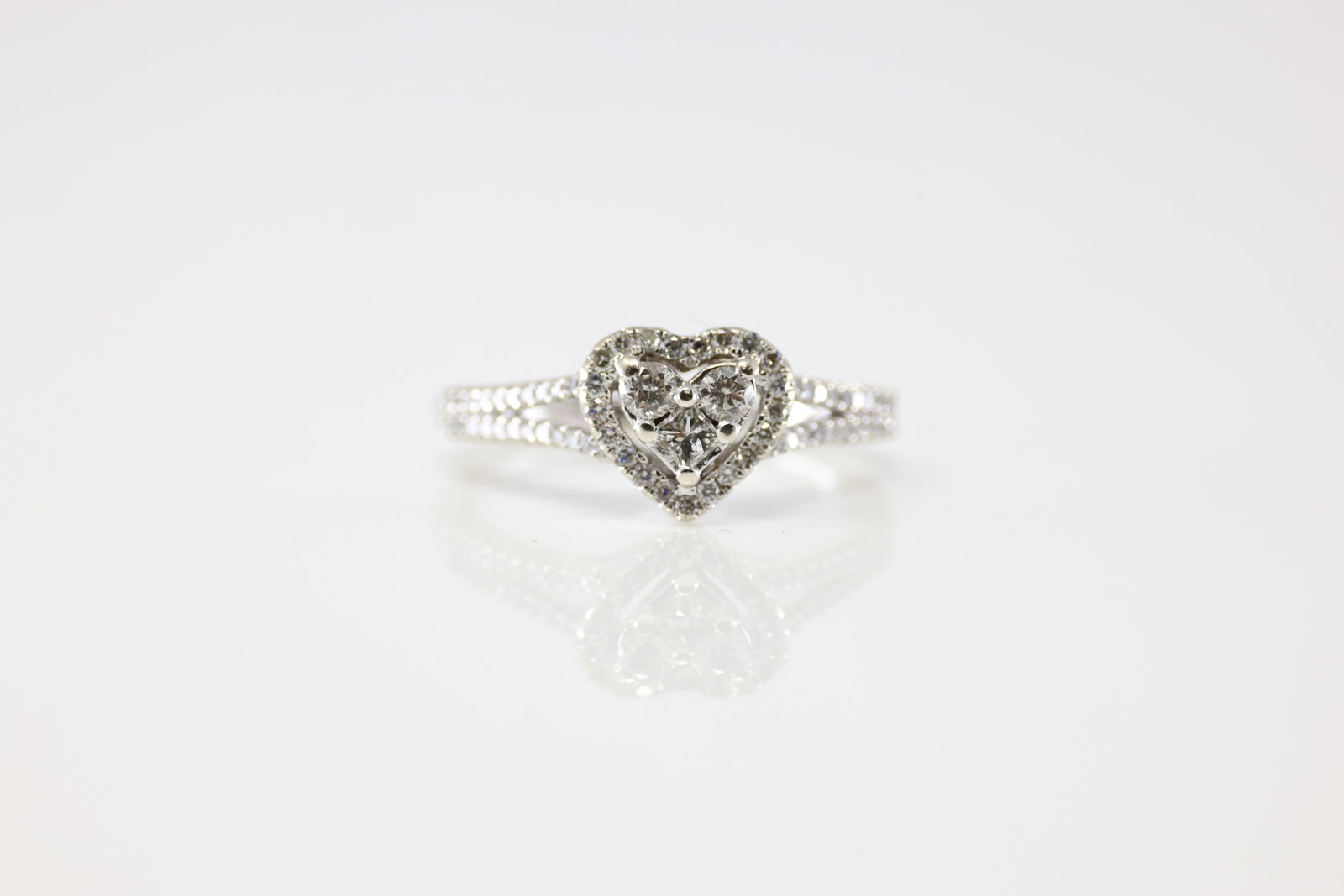 Diamond Ring 10Kt.: Ladies 10Kt White Gold Diamond Ring. This Ring has Heart Design With 63 Round Sparkling Diamonds. Diamond Weight Approx: 1.00ctw. Ring Size: 7.00. Total Weight: 2.82 Grams.