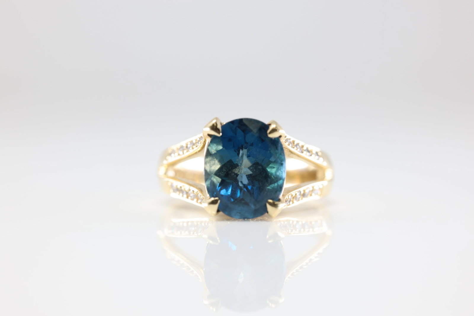 Blue Topaz & Diamond Ring 14Kt.: Ladies 14Kt Yellow Gold Blue Topaz & Diamond Ring. This Ring has Beautifull Blue Topaz Gemstone In The Center With Diamonds By Each Side. Diamond Weight Approx: 0.20 ctw. Ring Size: 6.50. Total