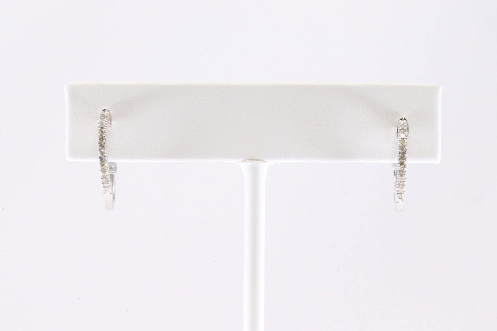 Diamond Hoop Earring 10Kt.: Ladies 10Kt White Gold Diamond Hoop Earring. This Gorgeous Earring has 28 Round Sparkling Diamonds. Diamond Approx Weight: 0.21 ctw.