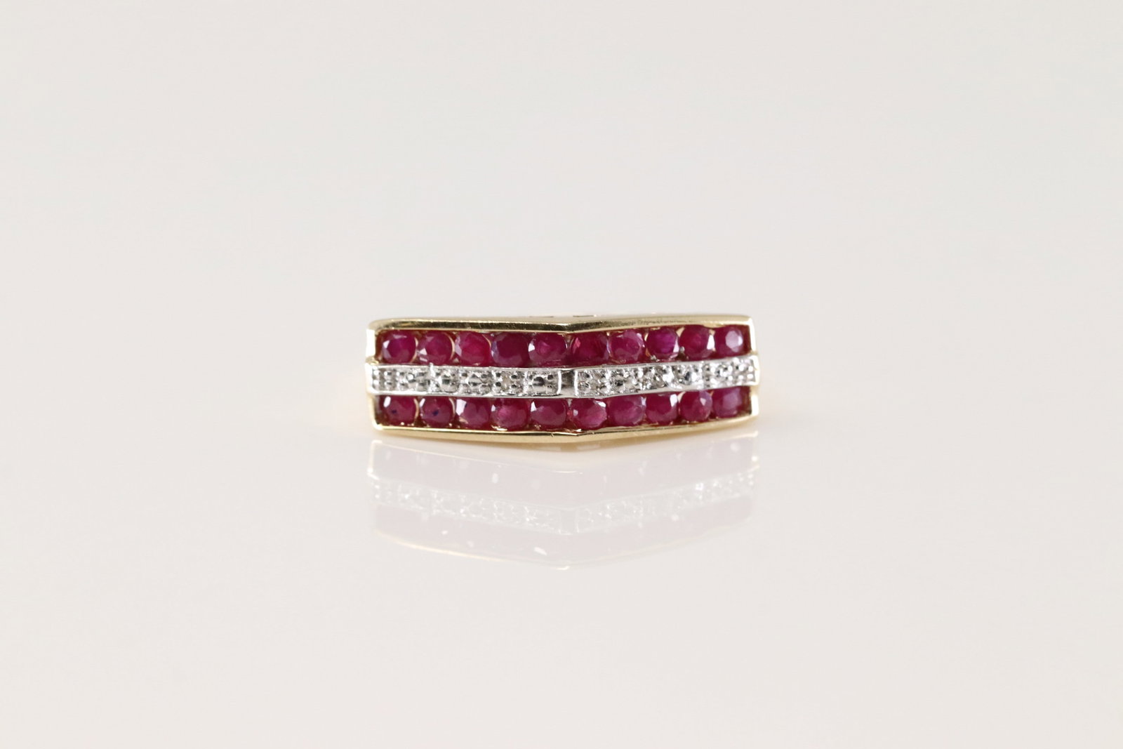 Ruby & Diamond Ring 10Kt.: Ladies 10Kt Yellow Gold Ruby & Diamond Ring. This Ring has 20 Gorgeous Ruby Gemstones & 10 Round Sparkilng Diamonds. Diamond Weight Approx: 0.35ctw Ring Size: 7.00. Total Weight: 3.10 Grams.