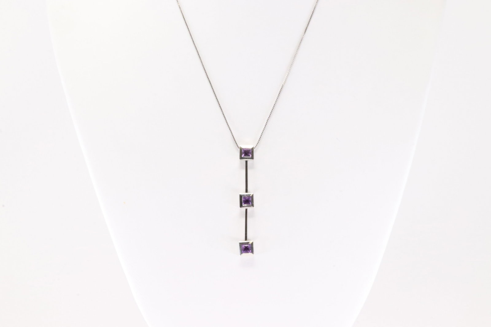 Amethyst Pendant / Necklace 18Kt.: 18Kt White Gold Amethyst Pendant / Necklace. This Elegant Pendant has 3 Square Purple Amethyst Gemstone with A 14K Necklace. Necklace length: 16.00" Total weight: 5.70 Grams.