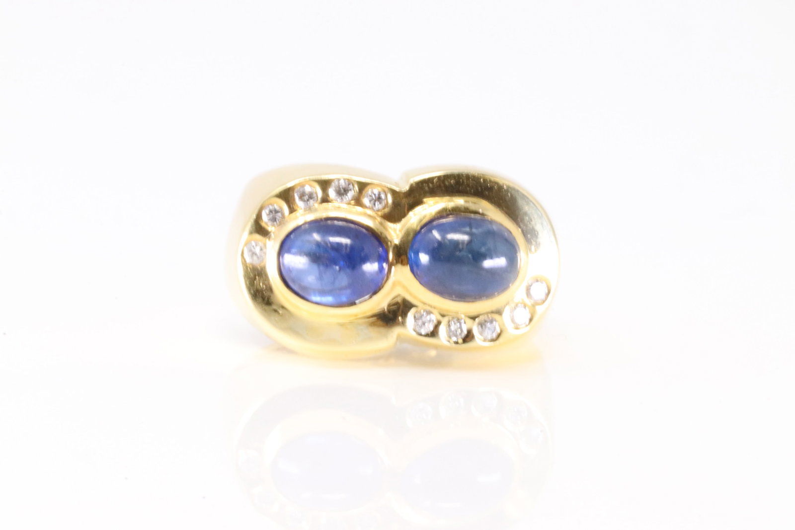 Boucheron Cabochon Sapphire & Diamond Ring 18Kt.: Boucheron 18Kt Yellow Gold Cabochon Sapphire & Diamond Ring. This Ring has 2 Cabochon Sapphire Gemstones With 10 Round Sparkling Diamonds. Ring Size: 7.00. Total Weight: 6.95 Grams.