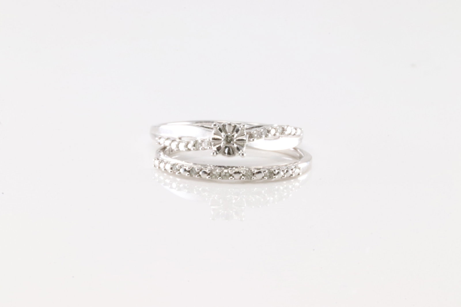 Engagement & Wedding Diamond Ring Set 14Kt.: Ladies 14Kt White Gold Engagement & Wedding Diamond Ring. This elegant set has one engagement and wedding band rings with 27 round diamonds between both. Diamonds weight: 0.23ctw. Rings size: 7.00.