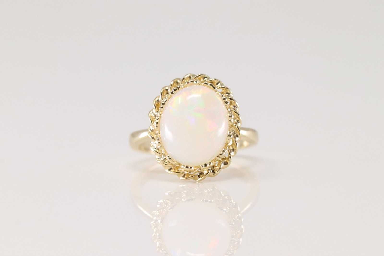 Opal Gemstone Ring 14Kt.: Ladies 14Kt Yellow Gold Opal Ring. This Ring has A Beautiful Round Opal Gemstone In The Center. Ring Size: 6.00. Total Weight: 4.50 Grams.