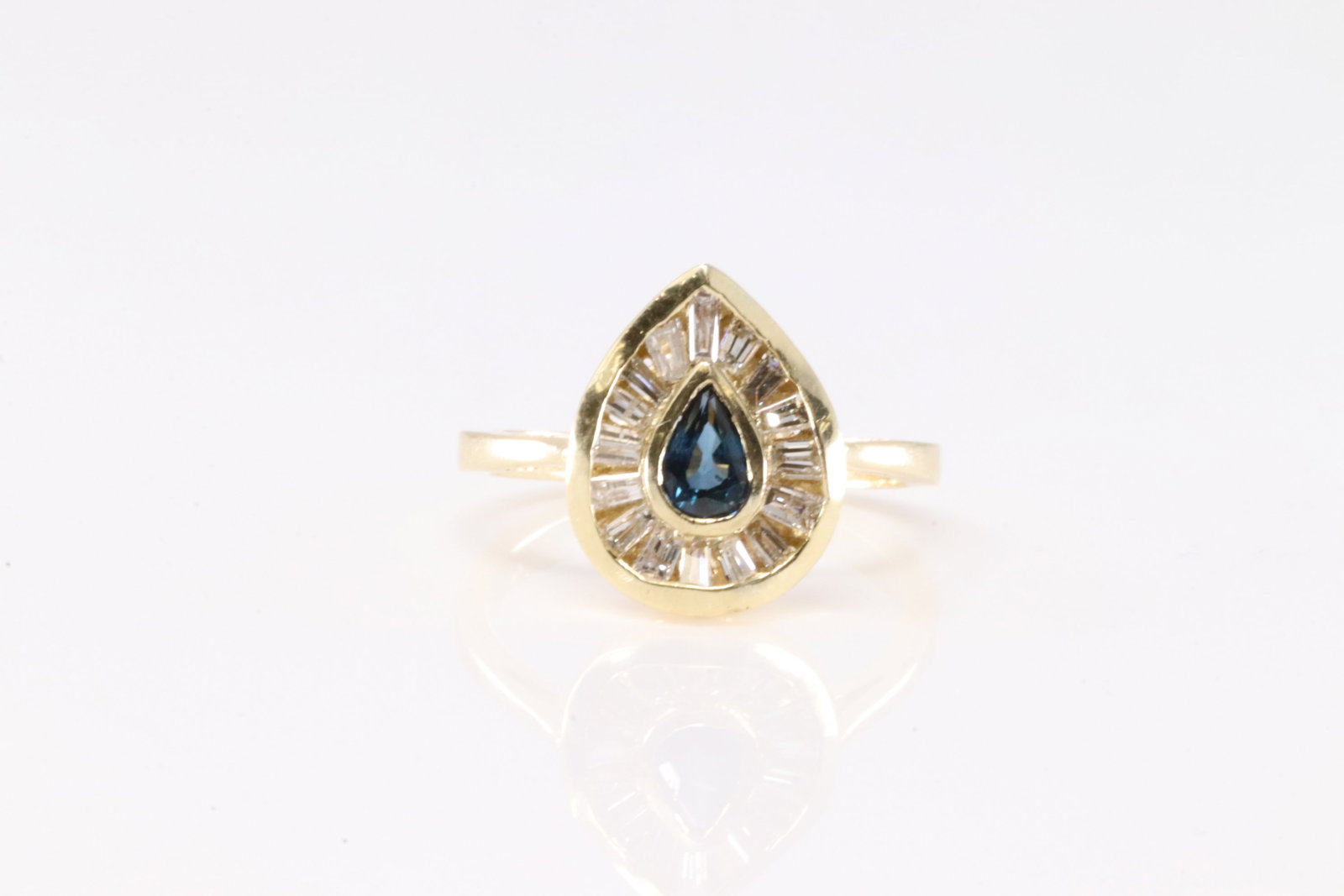 Sapphire & Diamond Ring 14Kt.: Ladies 14Kt Yellow Gold Sapphire & Diamond Ring. This Elegant Ring has Pear-Shaped Sapphire Surrender by Baguette Diamonds. Diamonds weight approx: 0.75 ctw Ring size: 6.25. Total weight: 3.55 Grams.