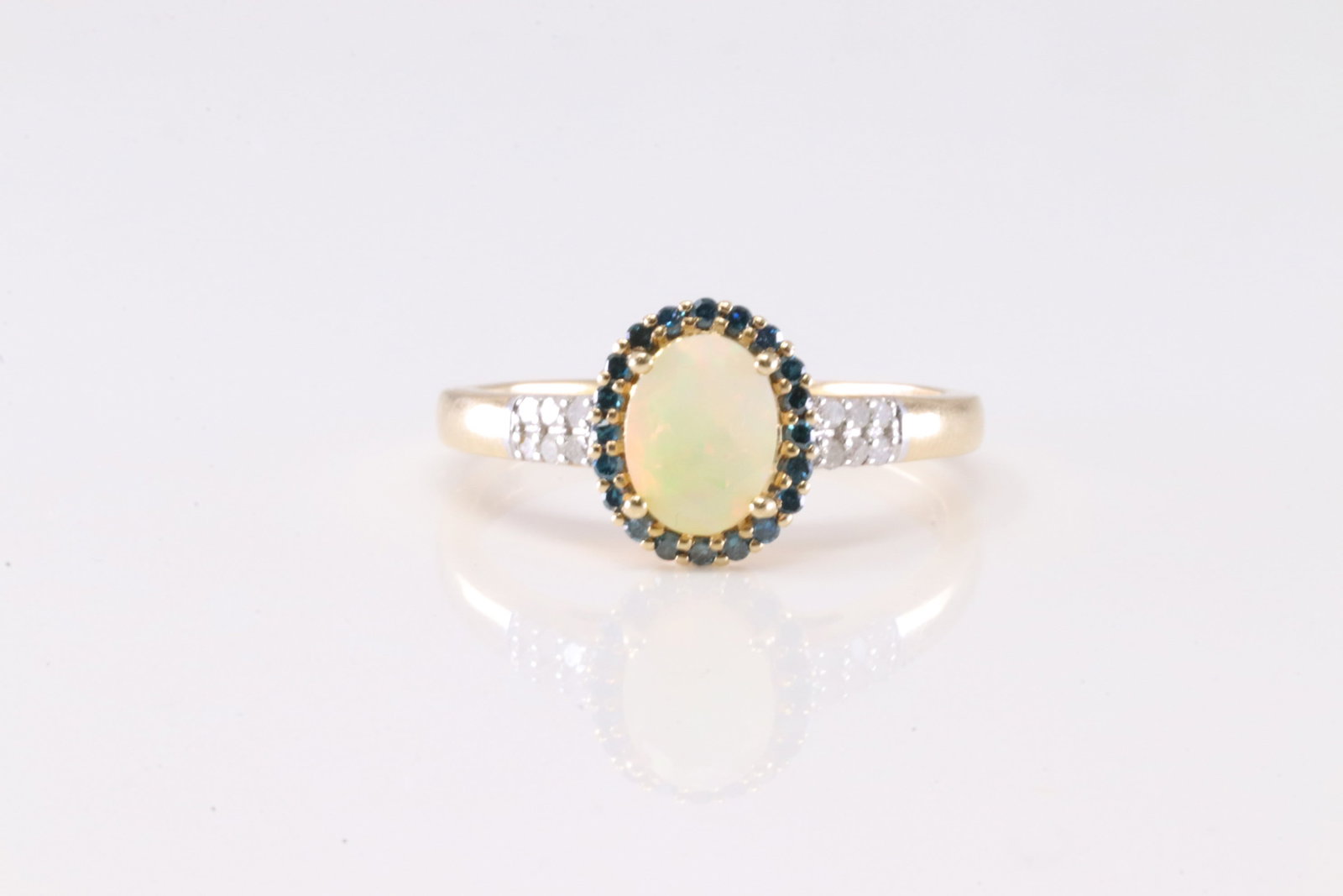 Opal Sapphire & Diamond Ring 14Kt.: Ladies 14Kt Yellow Gold Opal Sapphire & Diamond Ring. This Elegant Ring has A Opal Round Gemstone Surrounded With 20 Sapphire Gemstones & 12 Round Sparkling Diamonds. Ring Size: 9.00. Total Weight: