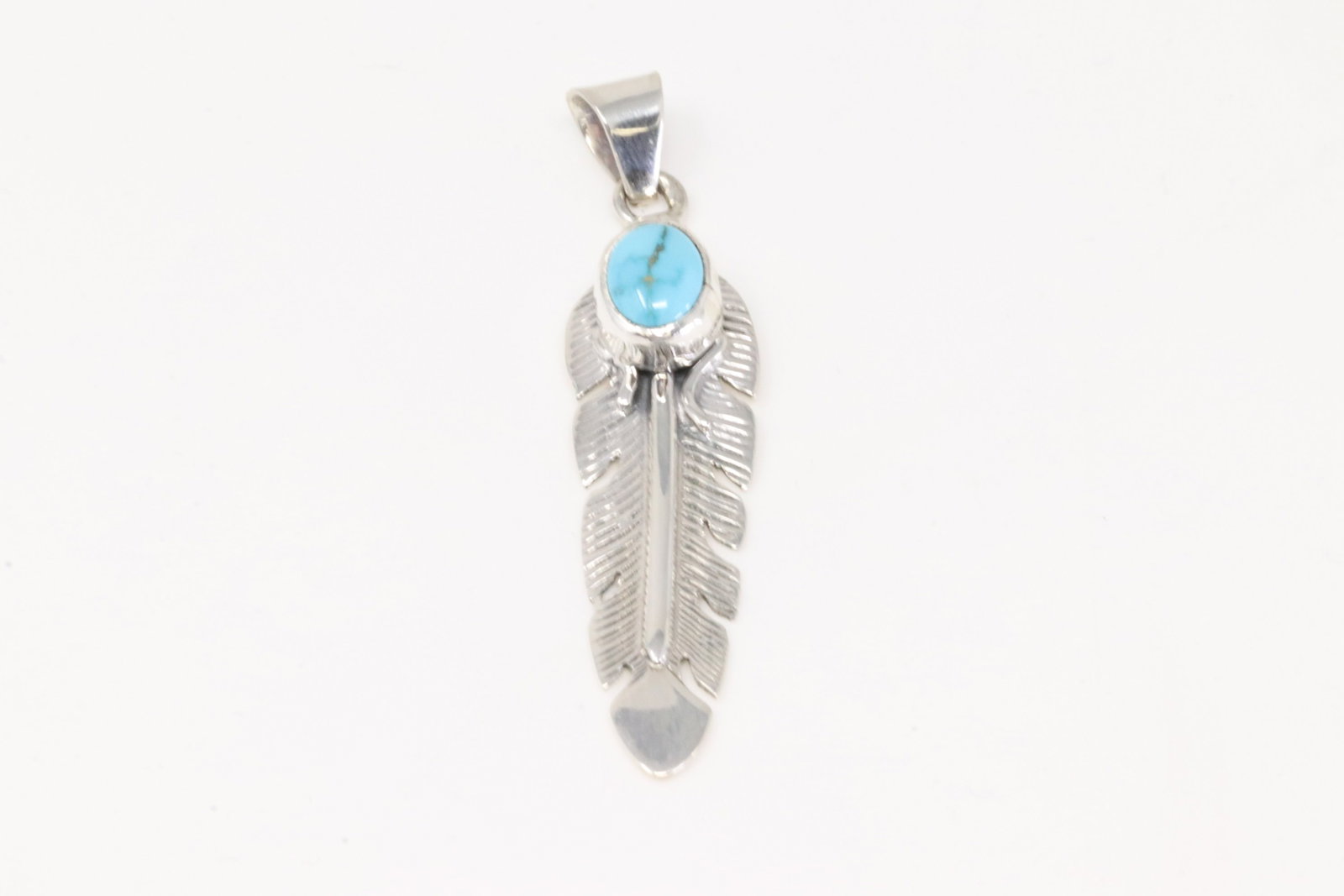 Native America Navajo Sterling Silver Turquoise Feather Pendant By June Delgarito.: This is a Native America Navajo Sterling Silver Turquoise Feather Pendant By June Delgarito.