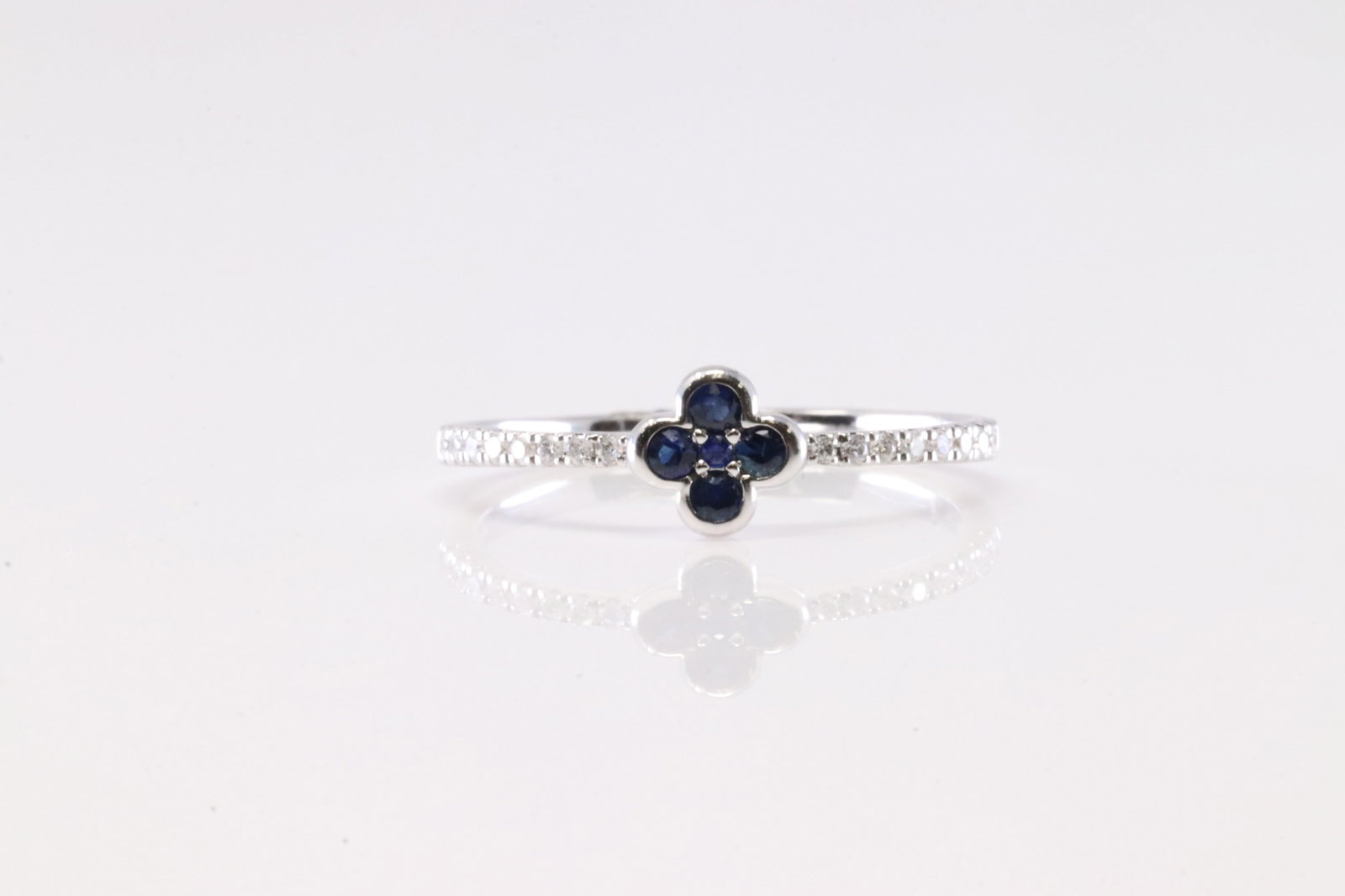 Sapphire & Diamond Flower Ring 14Kt.: Ladies 14Kt White Gold Sapphire & Diamond Flower Ring. This Ring has Flower Design with Sapphires and Sparkling Diamodns. Diamonds Weight: 0.10ctw. Sapphire Weight: 0.14ctw.