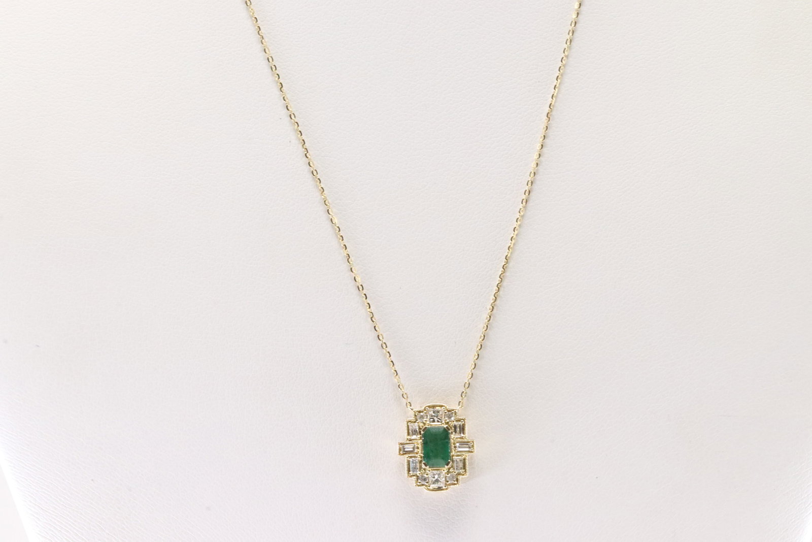 Emerald & Diamond Pendant / Necklace 14Kt.: Ladies 14Kt Yellow Gold Emerald & Diamond Pendant / Necklace. This Necklace has an Charming Pendant with Green Merald on the Center Surrender by Round & Baguette Diamonds. Diamonds weight: 0.34ctw.