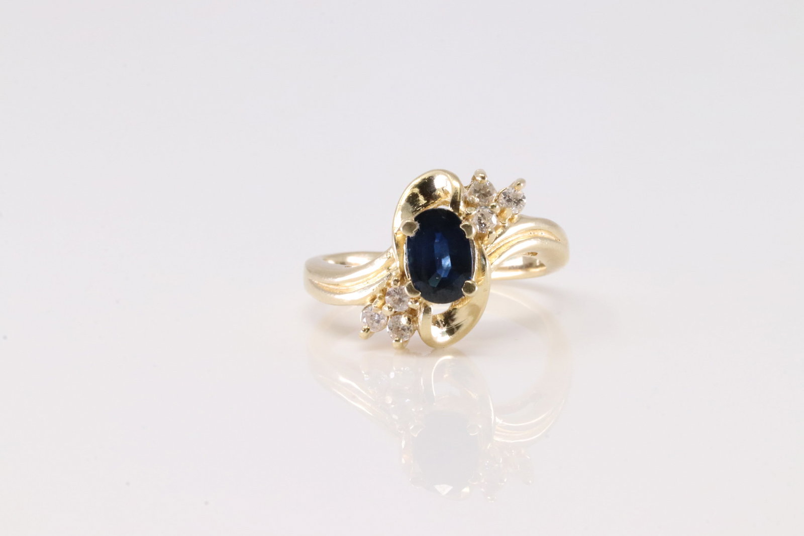 Sapphire & Diamond Ring 14Kt.: Ladies 14Kt Yellow Gold Sapphire & Diamond Ring. This Ring has A Gorgeous Oval Sapphire Gemstone With 6 Round Sparkling Diamonds. Diamond Approx Weight: 0.20ctw. Ring Size: 5.75. Total Weight: 4.55 Gr